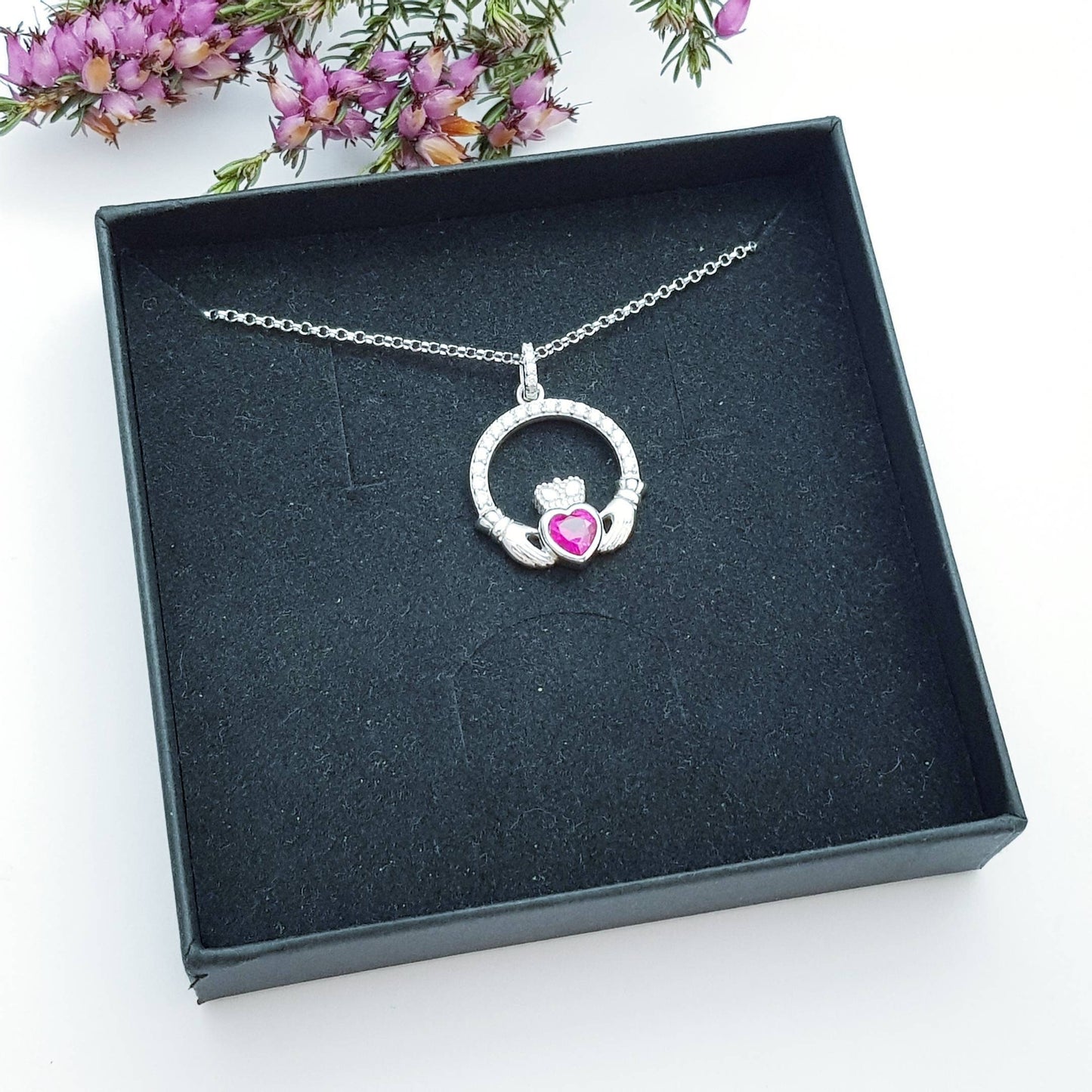 Sterling silver claddagh necklace set with ruby red July birthstone from Ireland