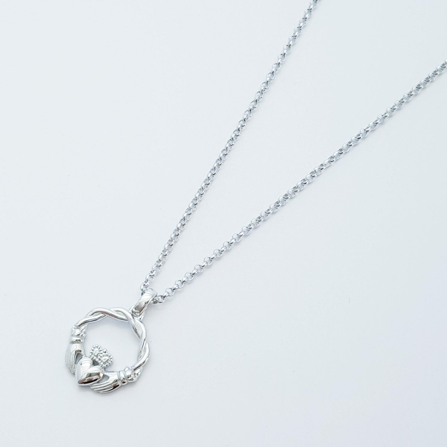 Small Sterling Silver claddagh necklace with gold plating and celtic braid.