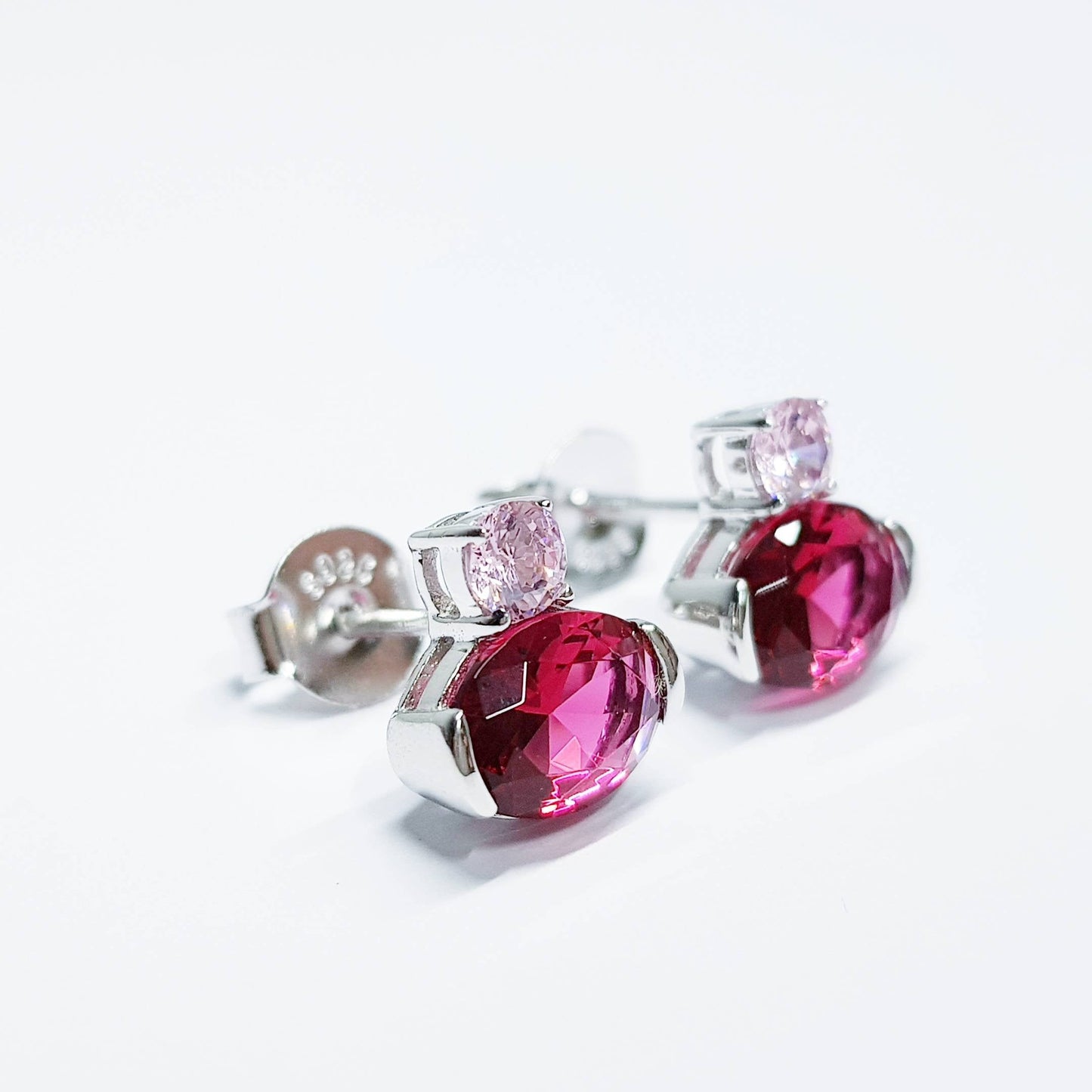 Sterling silver studs set with ruby red and pink cubic zirconia