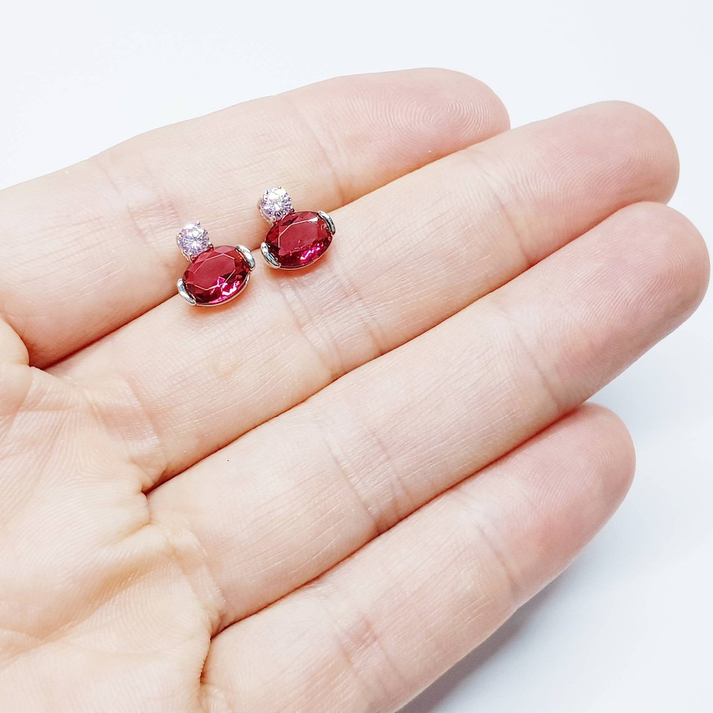 Sterling silver studs set with ruby red and pink cubic zirconia