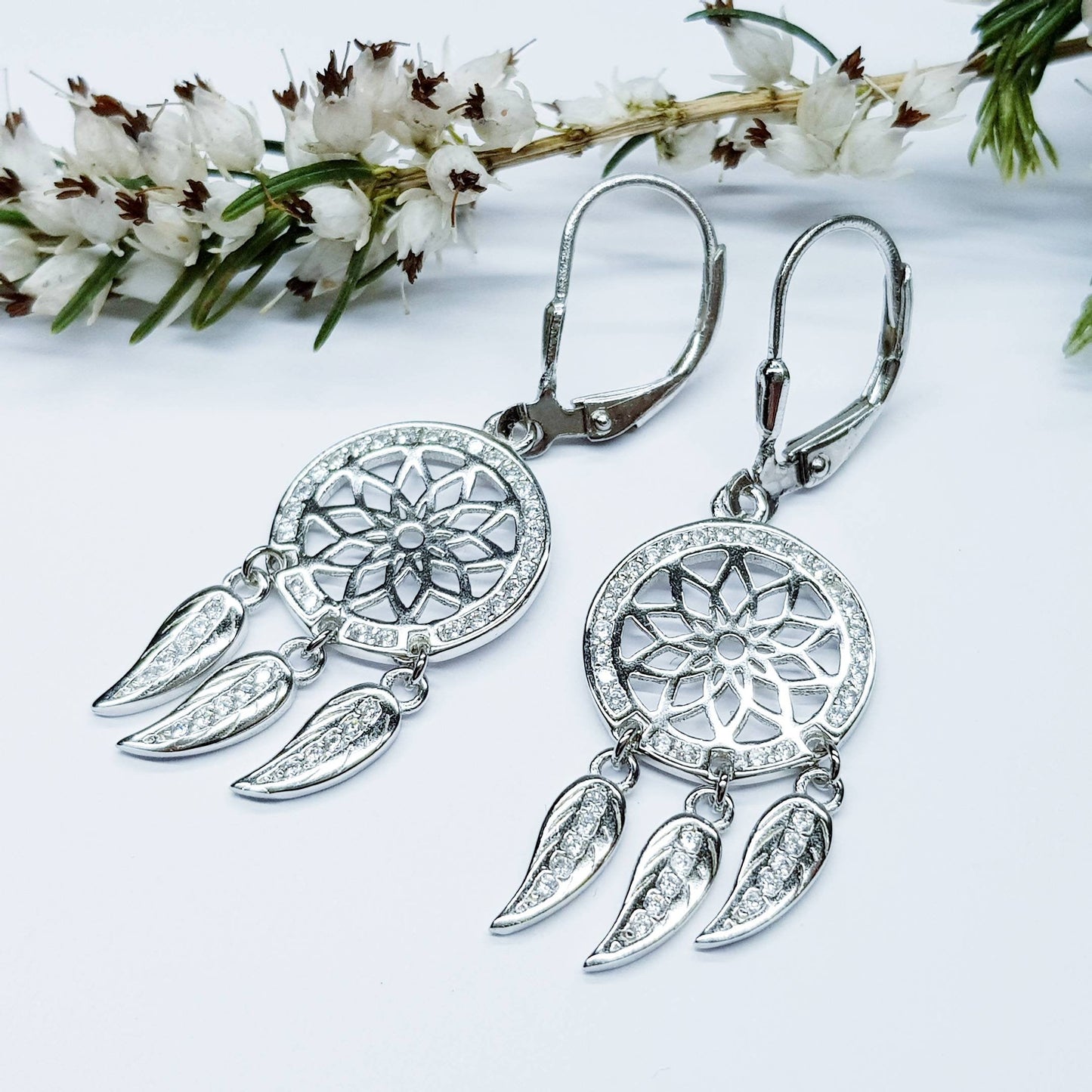 Sterling Silver drop earrings with sun symbol and dangling leaves