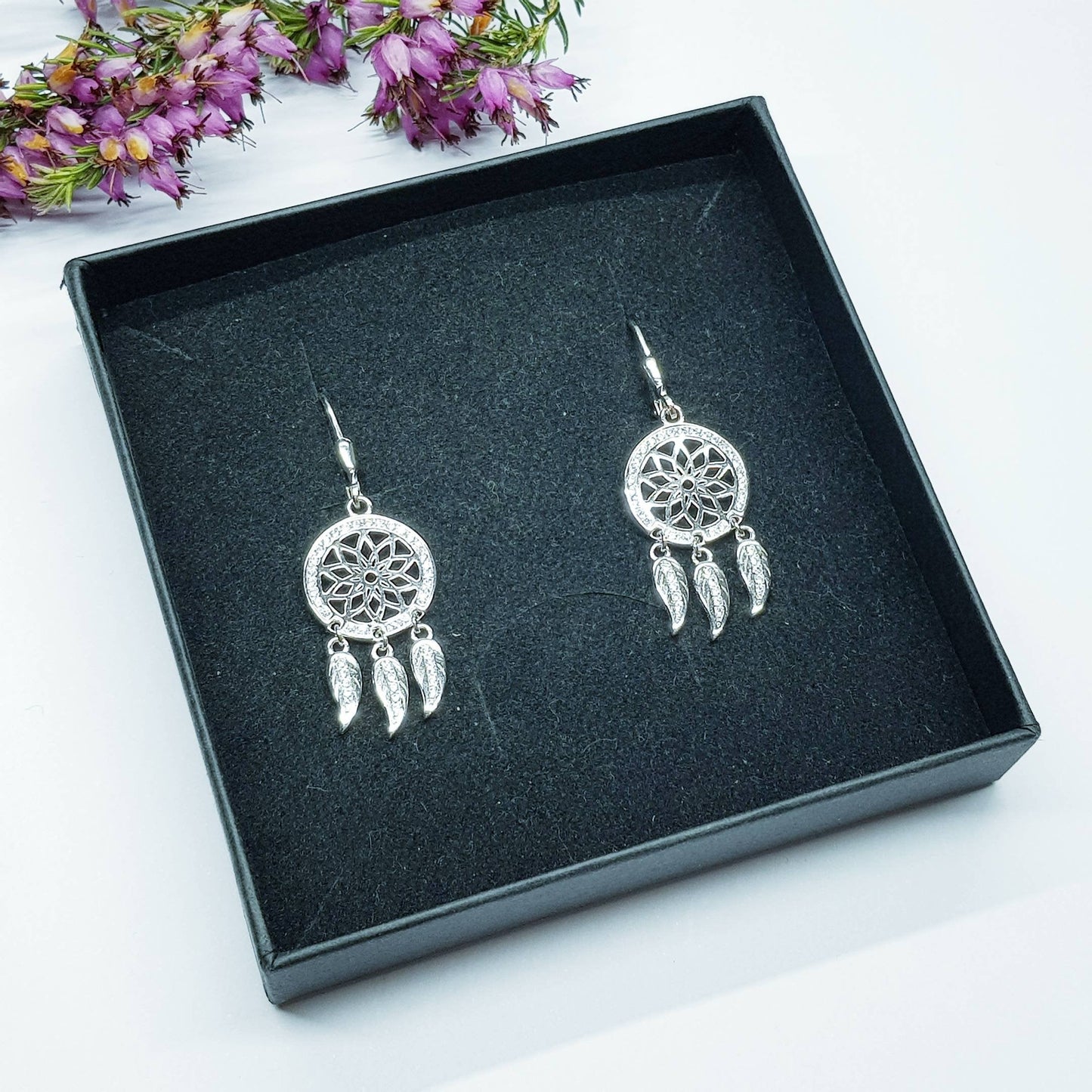 Sterling Silver drop earrings with sun symbol and dangling leaves