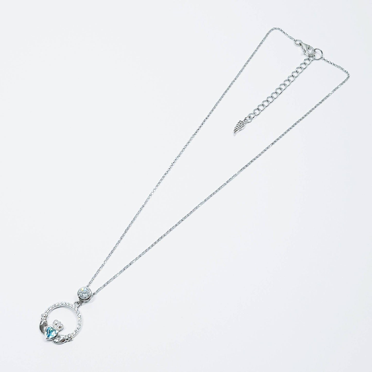 Sterling silver claddagh necklace set with electric blue December birthstone from Ireland