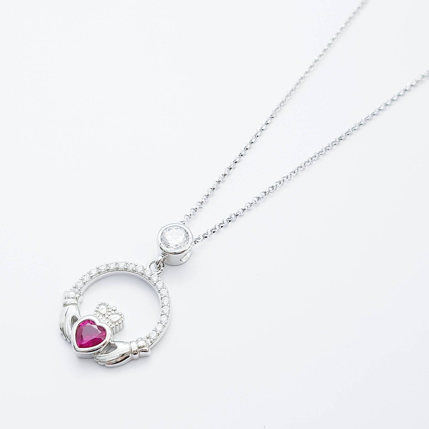 Sterling silver claddagh necklace set with ruby red July birthstone from Ireland