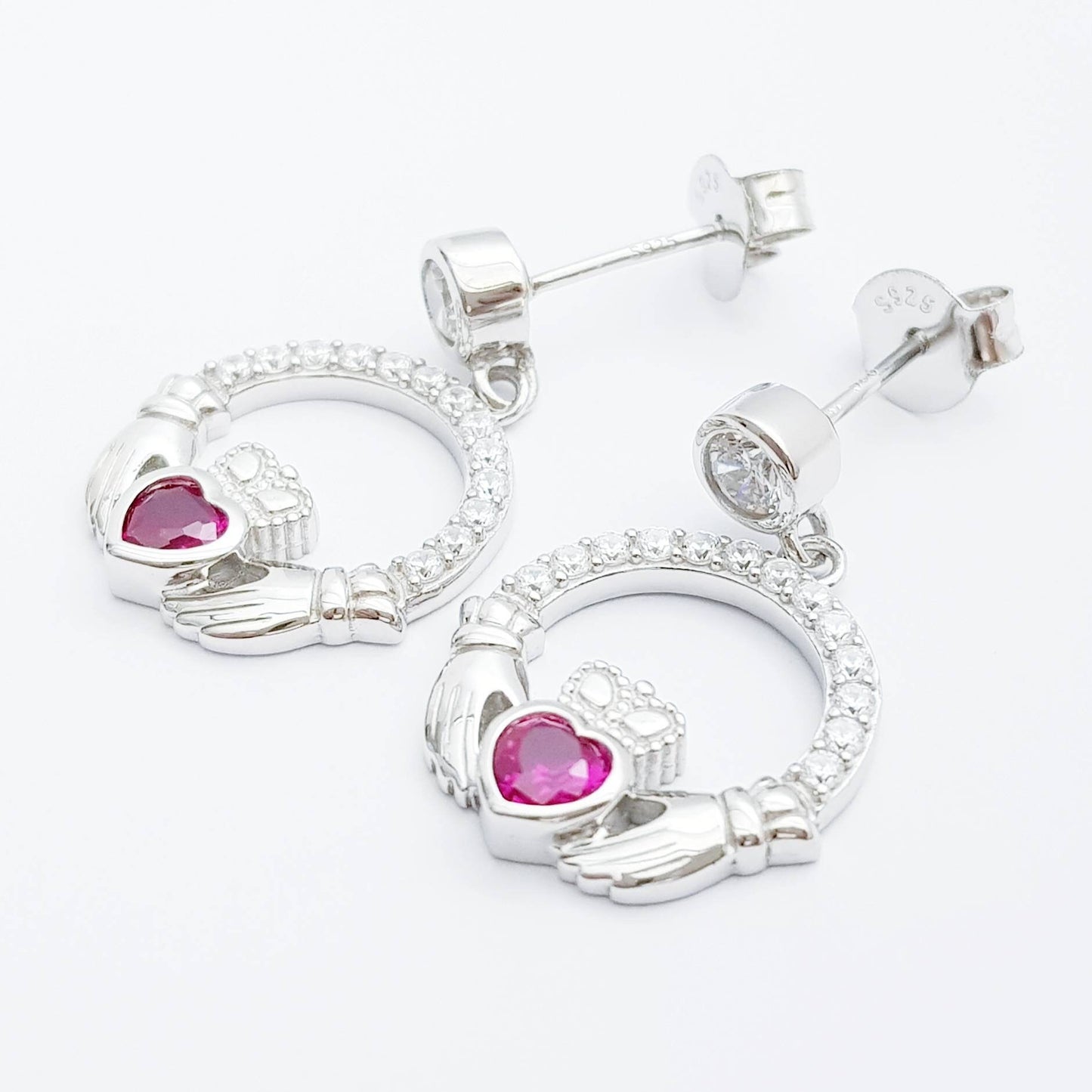 Silver claddagh drop earrings with red stone heart, July birthstone
