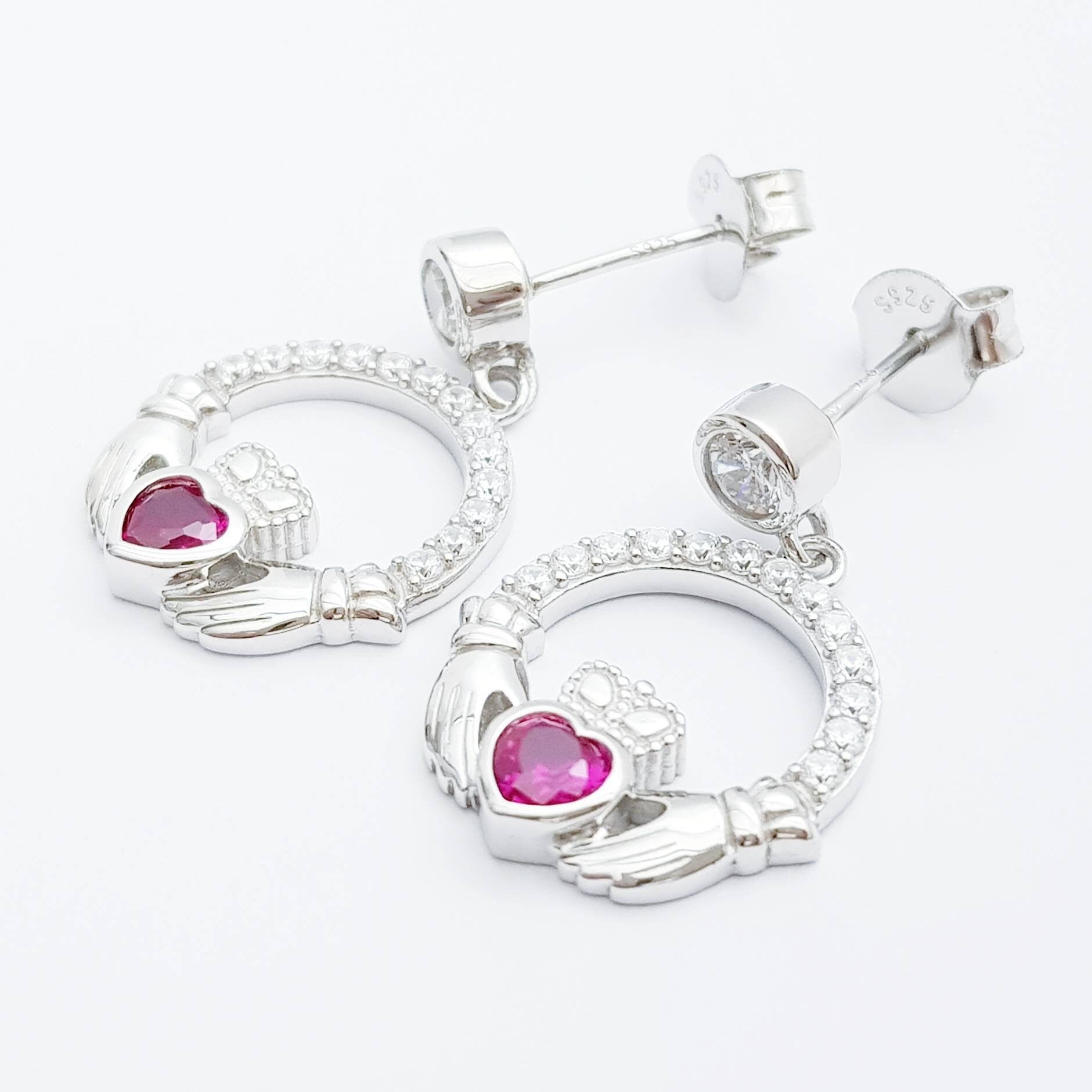Silver claddagh drop earrings with red stone heart, July birthstone