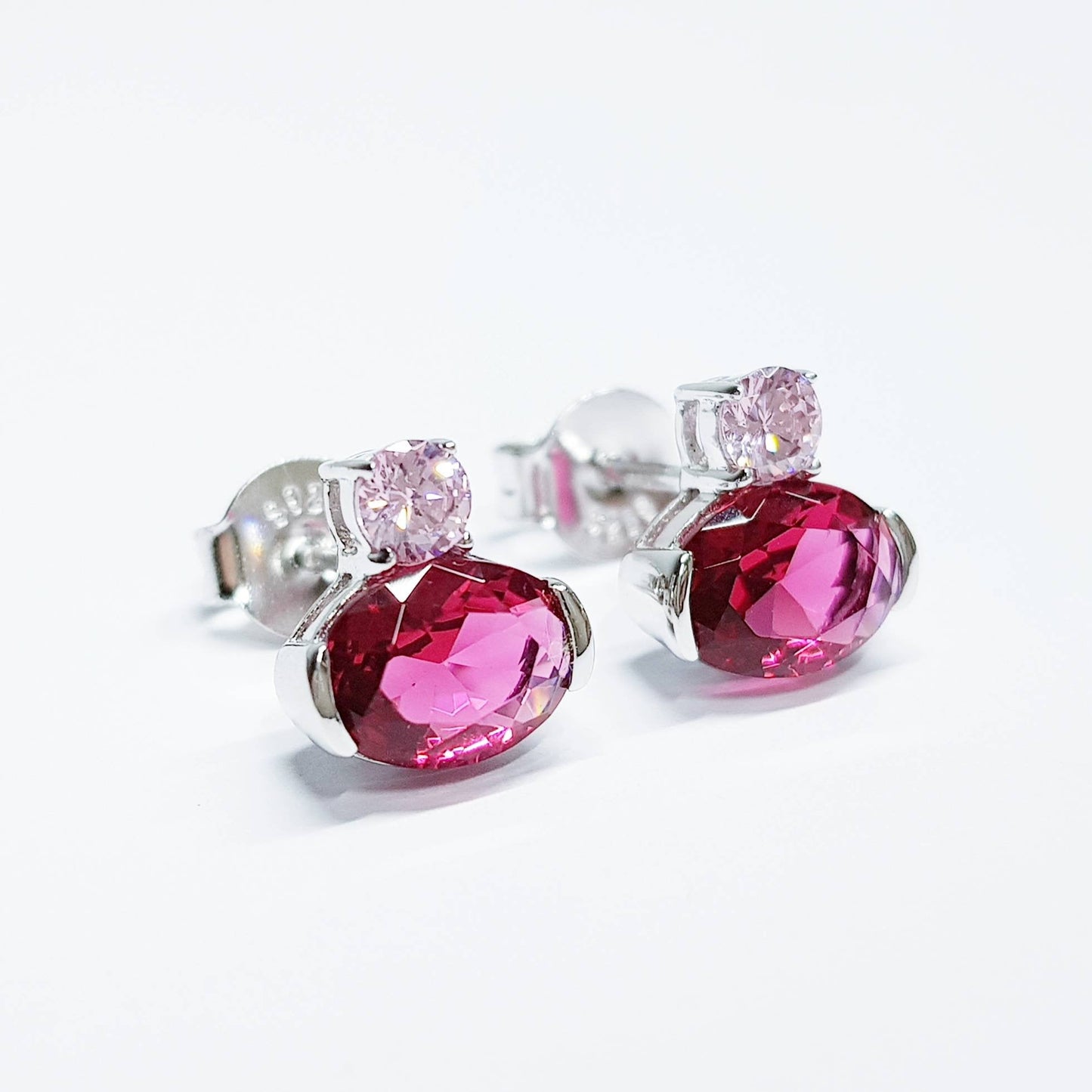 Sterling silver studs set with ruby red and pink cubic zirconia
