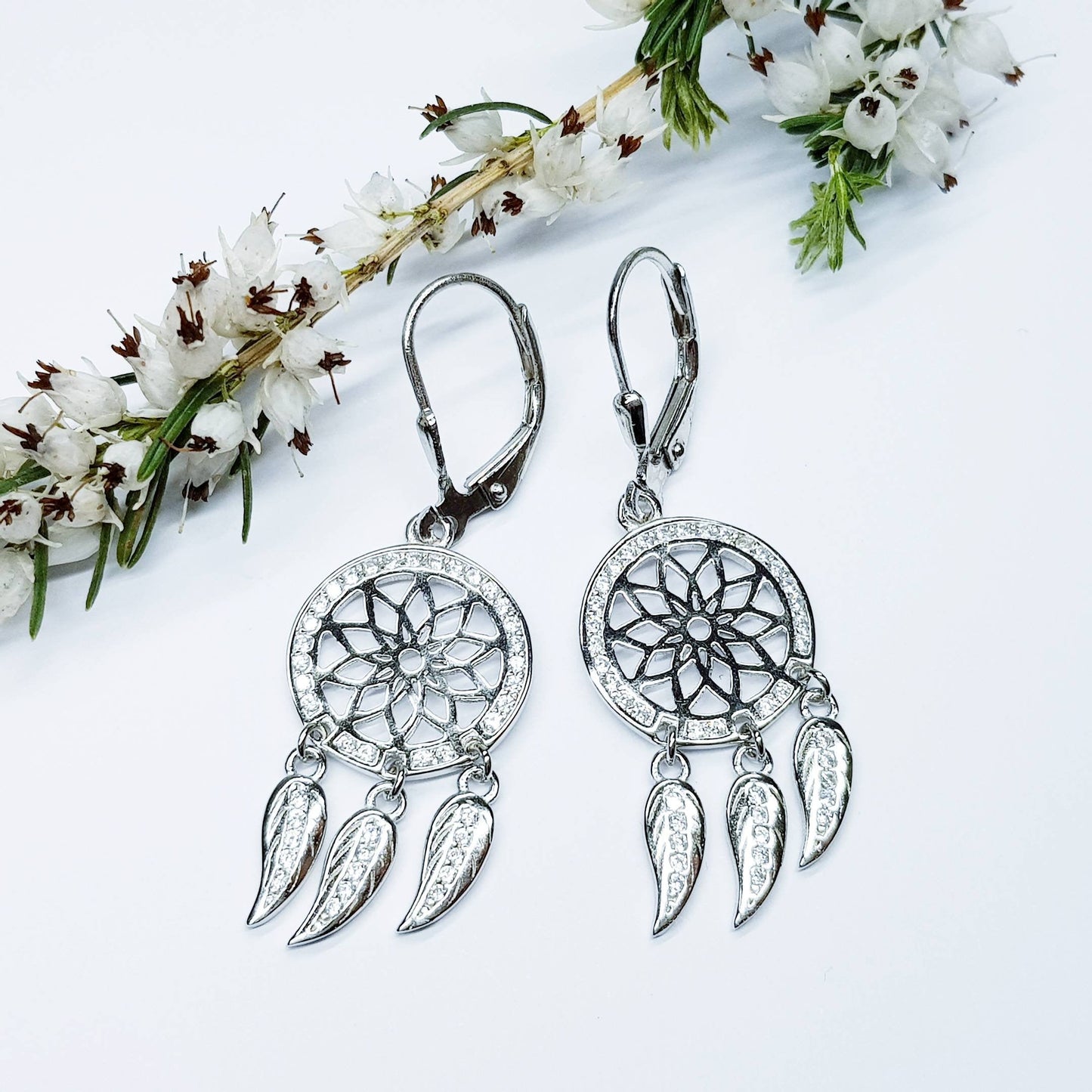 Sterling Silver drop earrings with sun symbol and dangling leaves