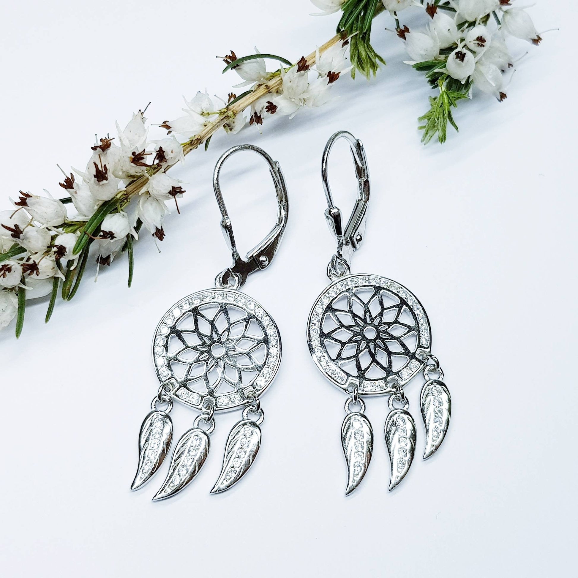 Sterling Silver drop earrings with sun symbol and dangling leaves