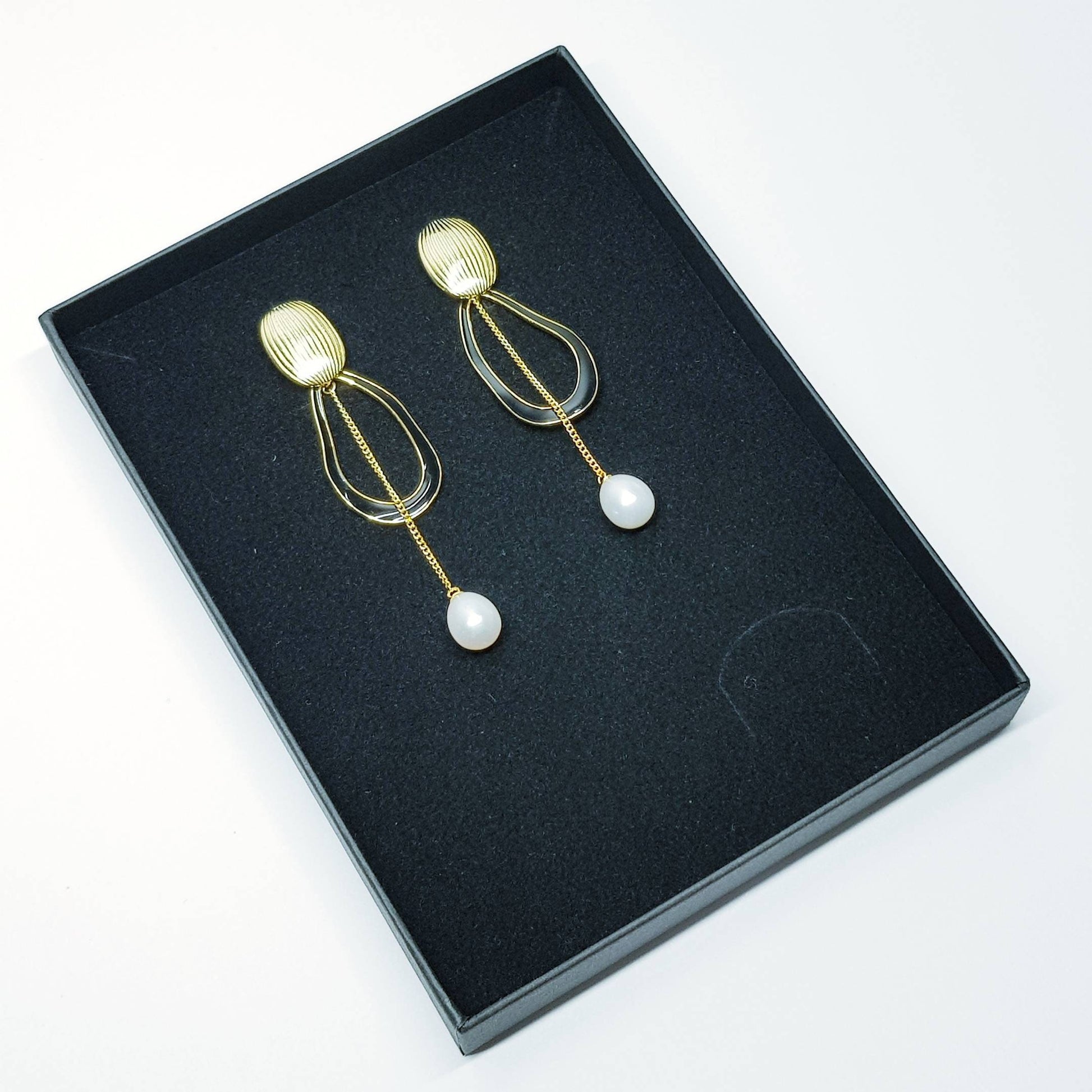 Modern floral inspired dress earrings with black lacquer and freshwater pearls