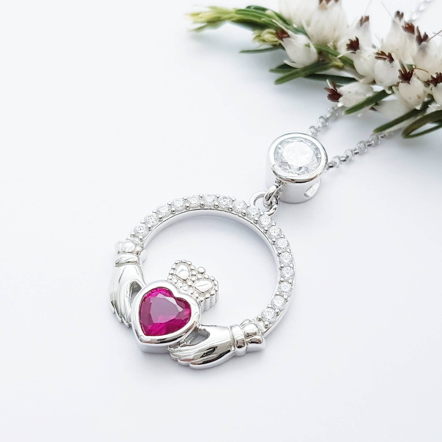 Sterling silver claddagh necklace set with ruby red July birthstone from Ireland