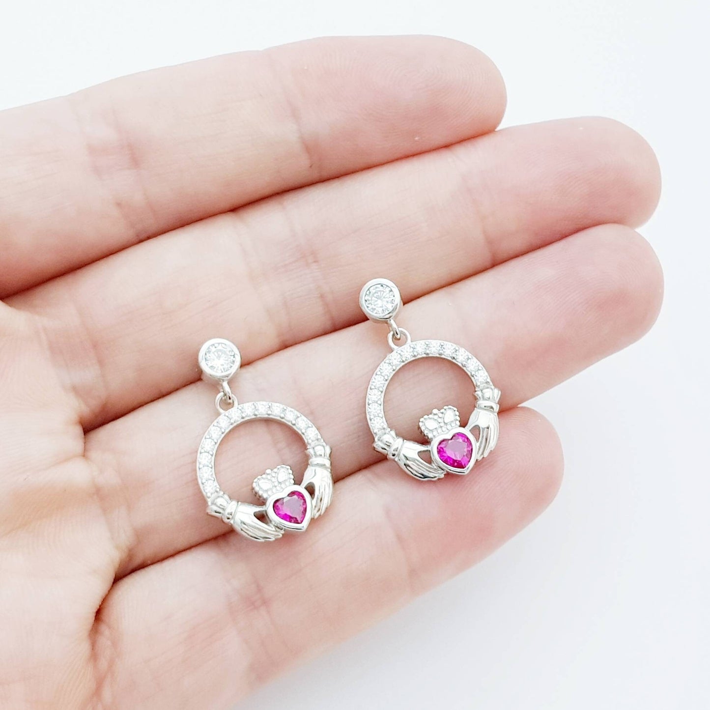 Silver claddagh drop earrings with red stone heart, July birthstone