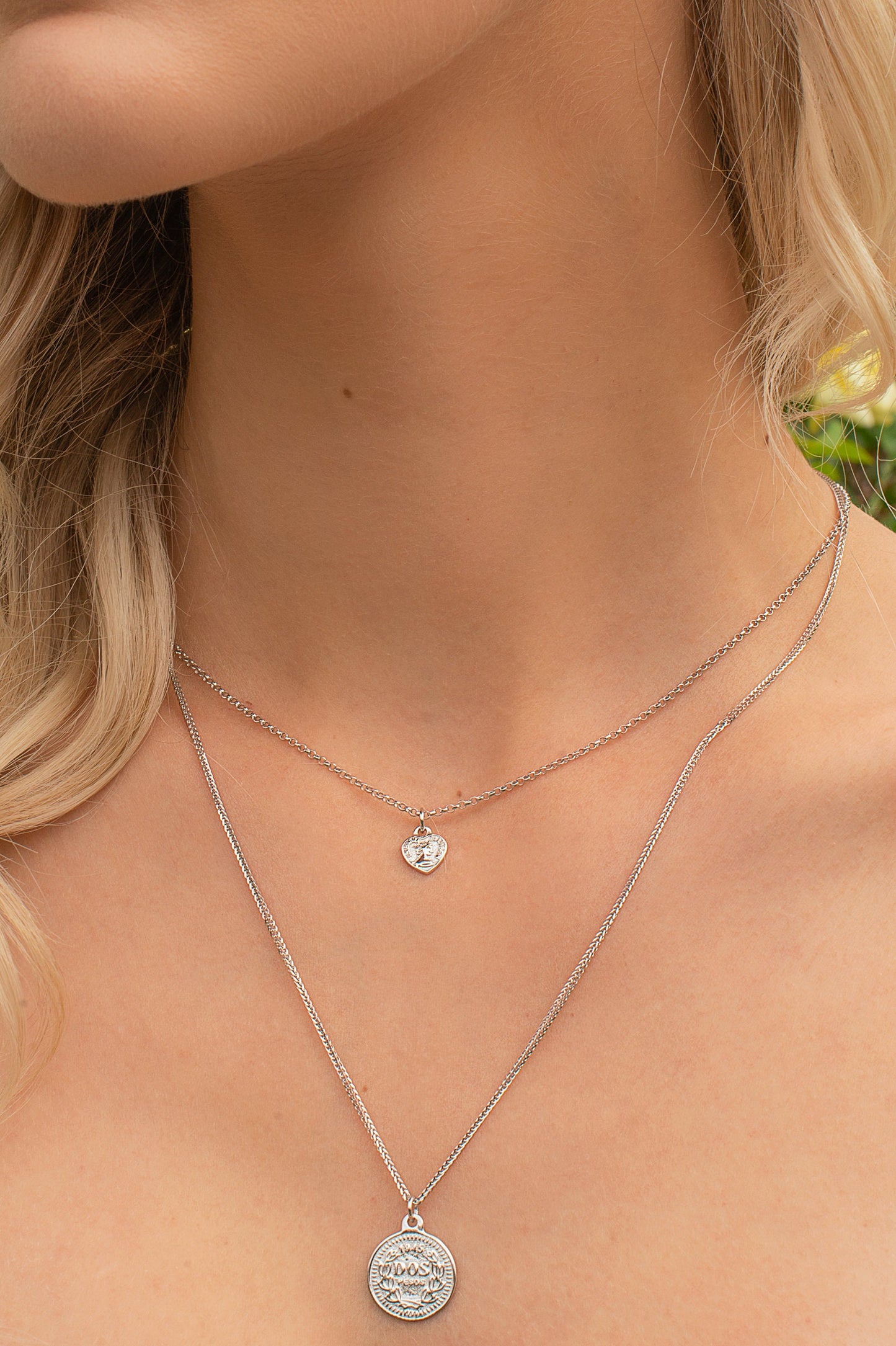 Sterling silver two strand layering necklace with coin and heart charm.