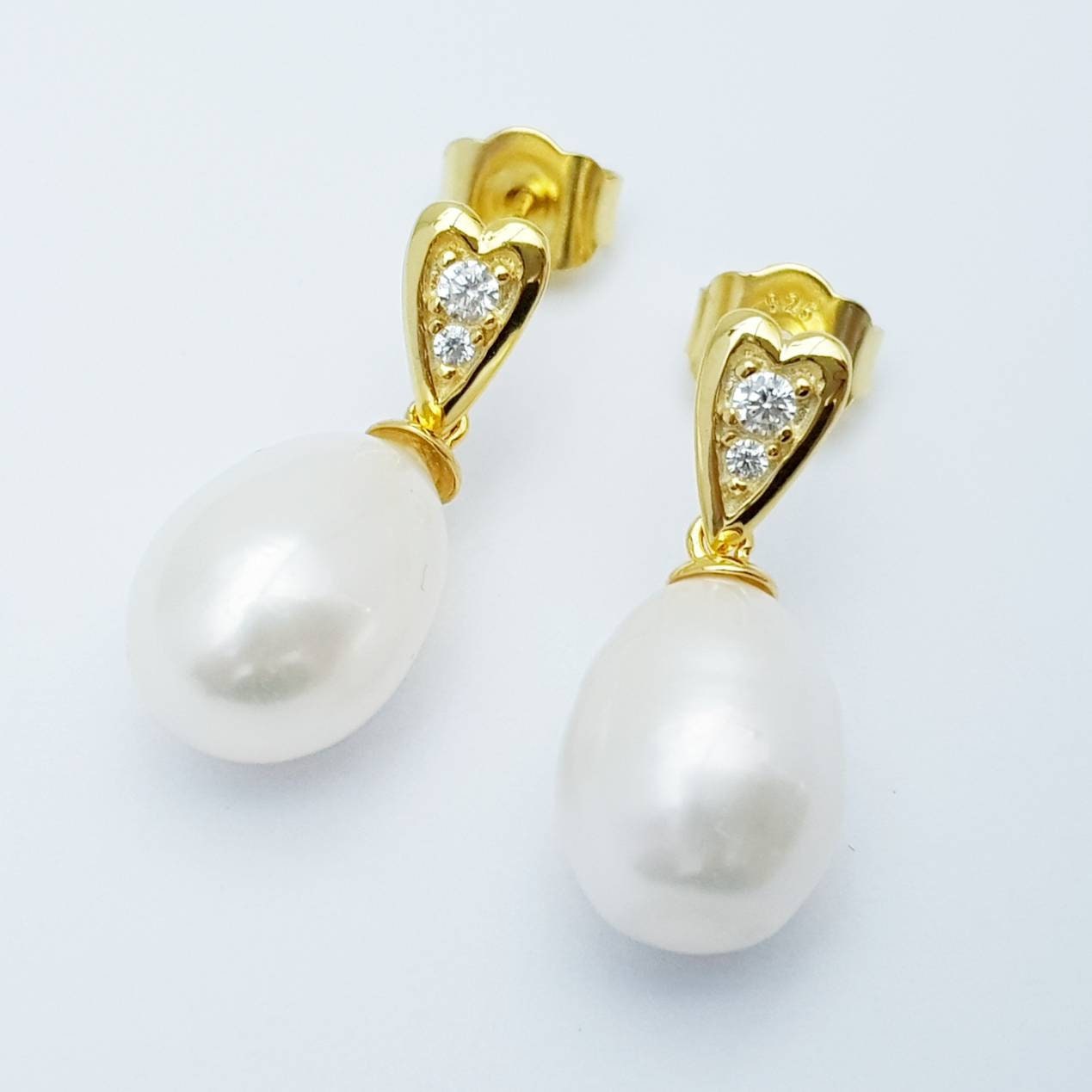 Sterling silver heart shaped earrings with large freshwater pearl drop.