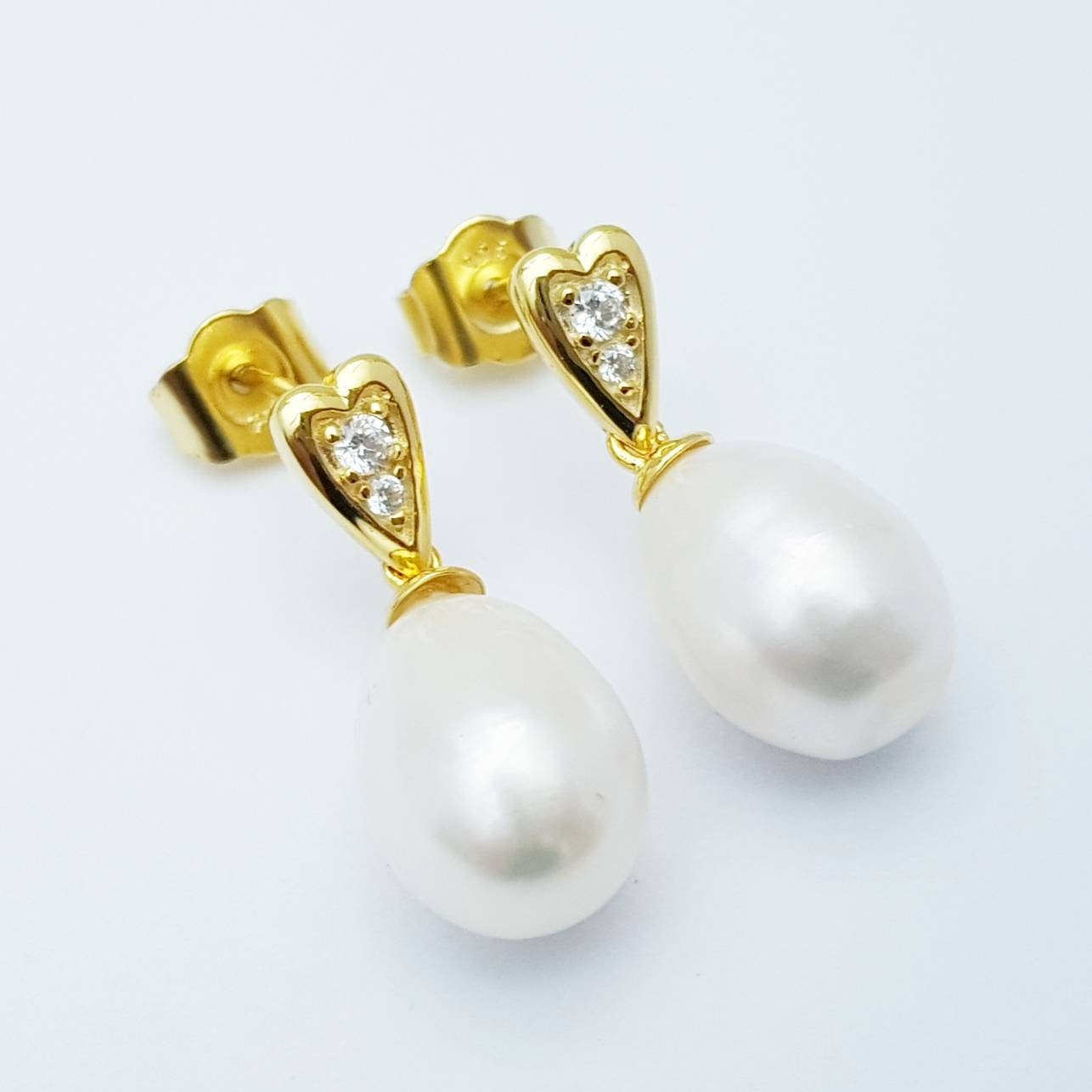 Sterling silver heart shaped earrings with large freshwater pearl drop.