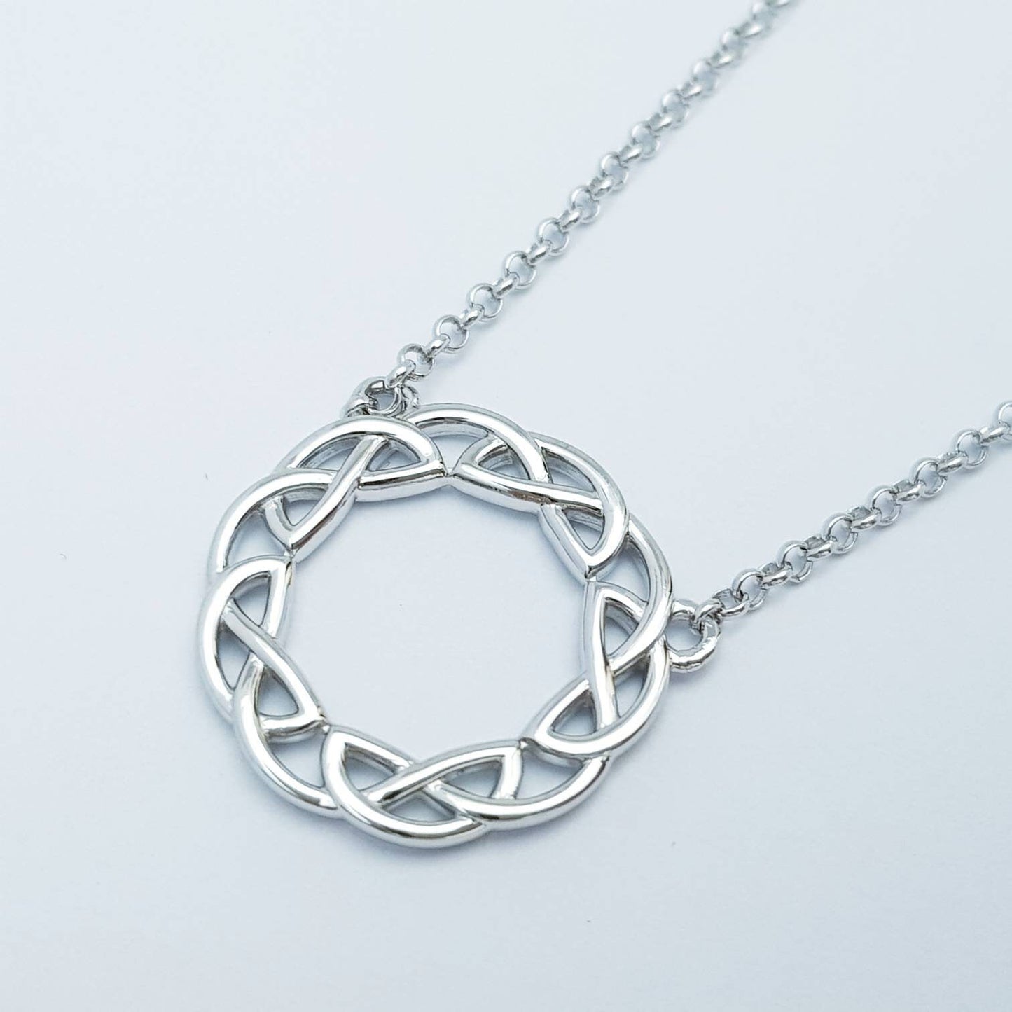 Double sided celtic knot pendant, silver round celtic necklace made in Ireland with angel wing chain