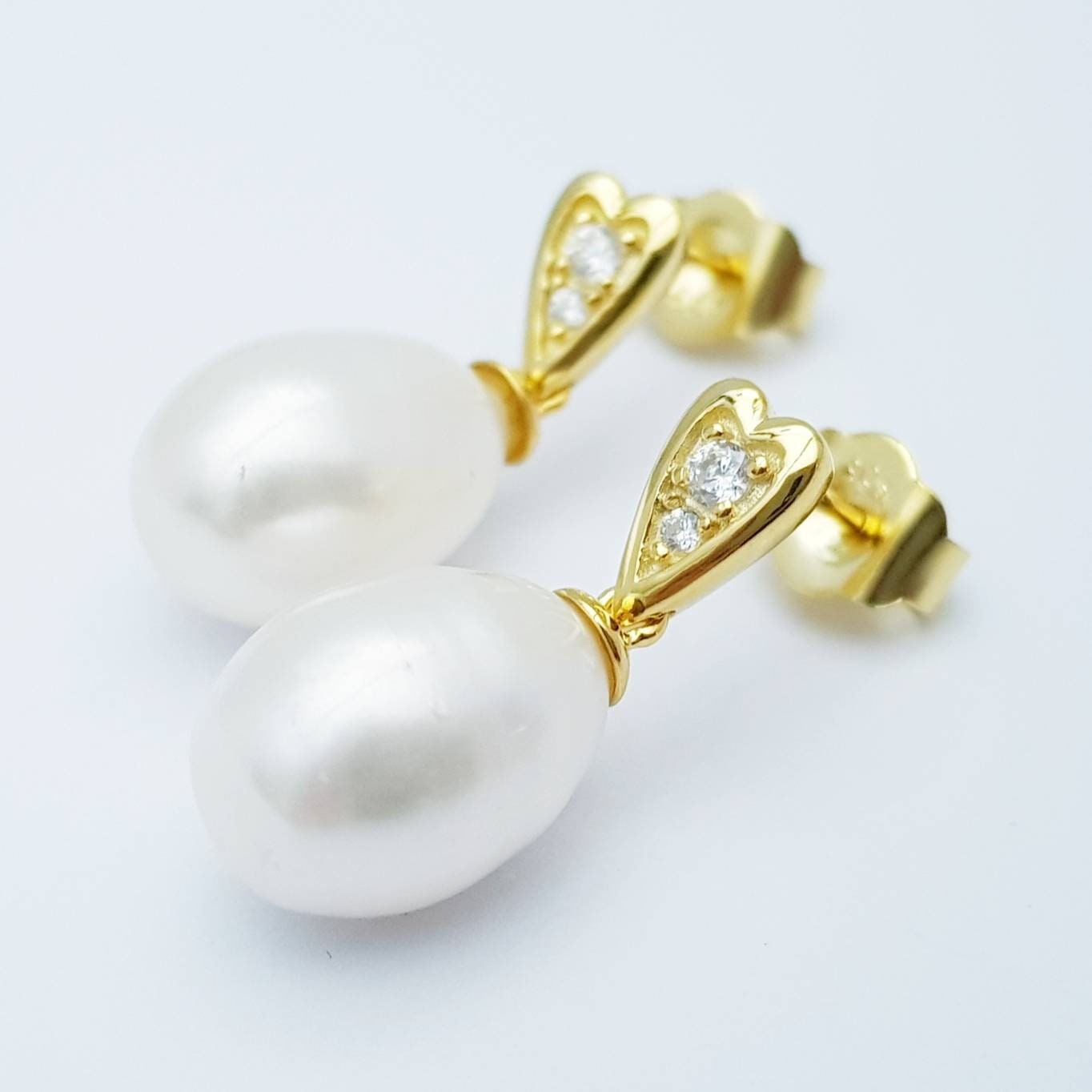 Sterling silver heart shaped earrings with large freshwater pearl drop.