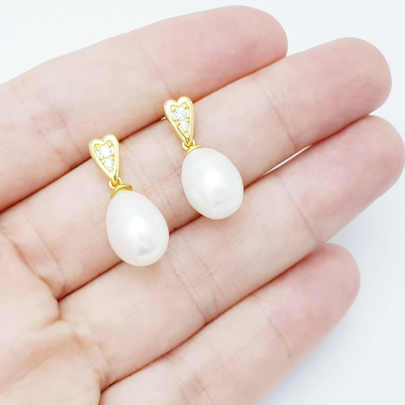 Sterling silver heart shaped earrings with large freshwater pearl drop.