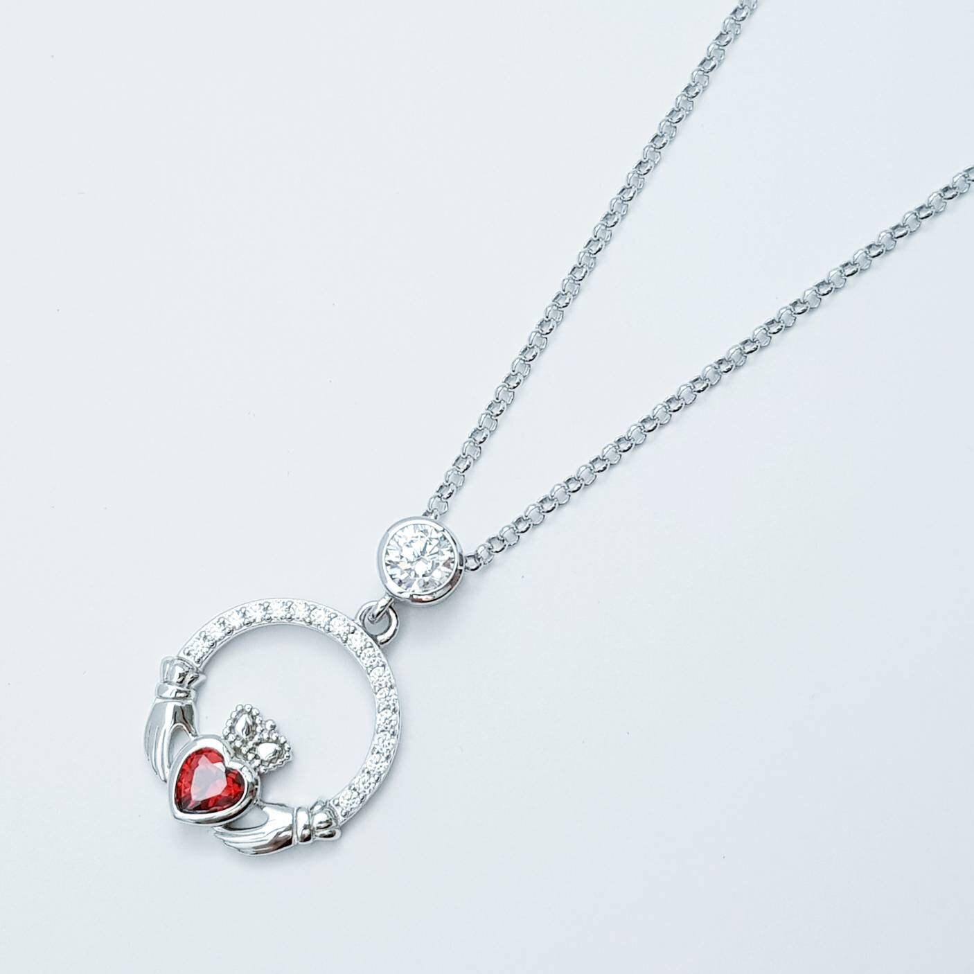Sterling silver claddagh necklace with red garnet heart shaped stone, January birthstone