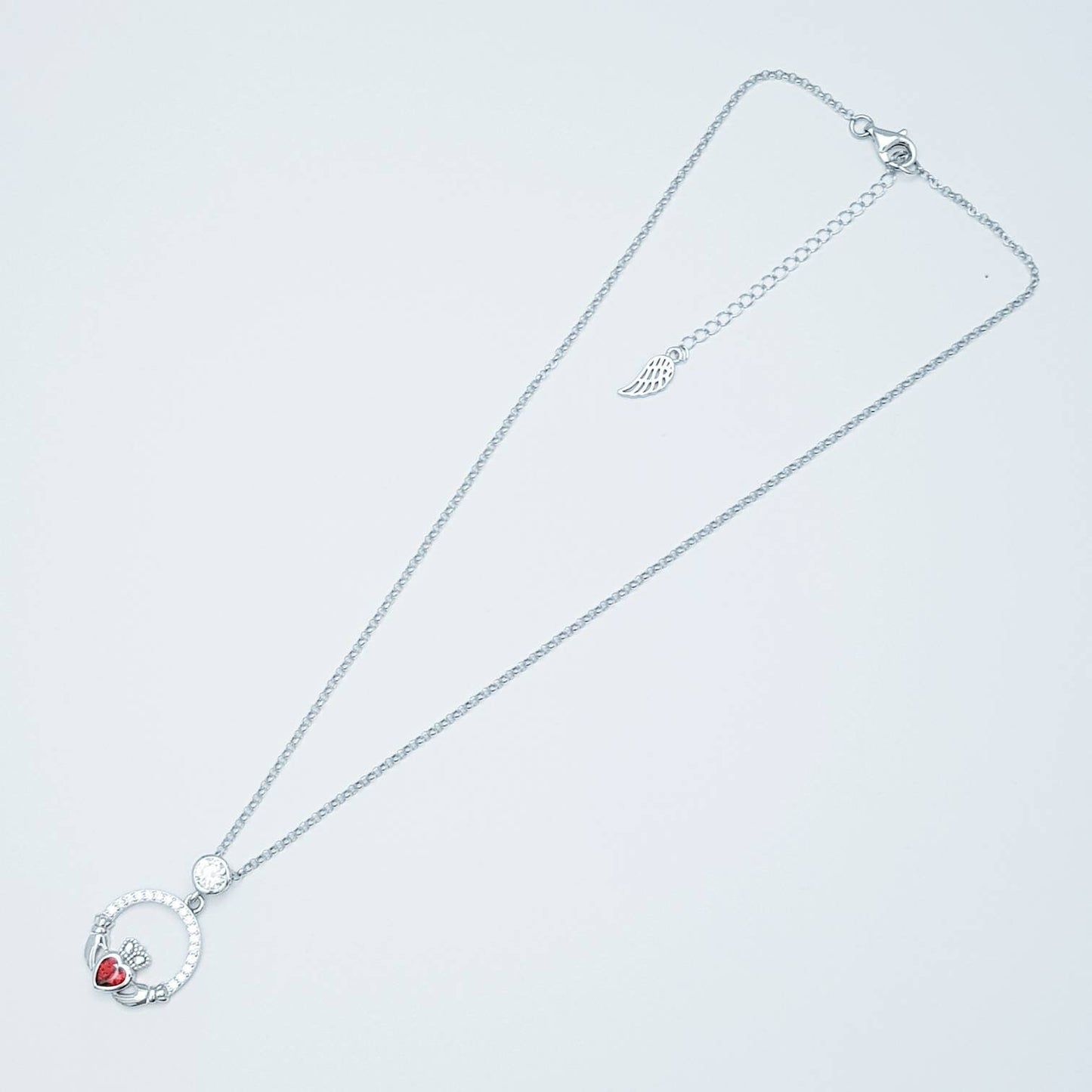 Sterling silver claddagh necklace with red garnet heart shaped stone, January birthstone