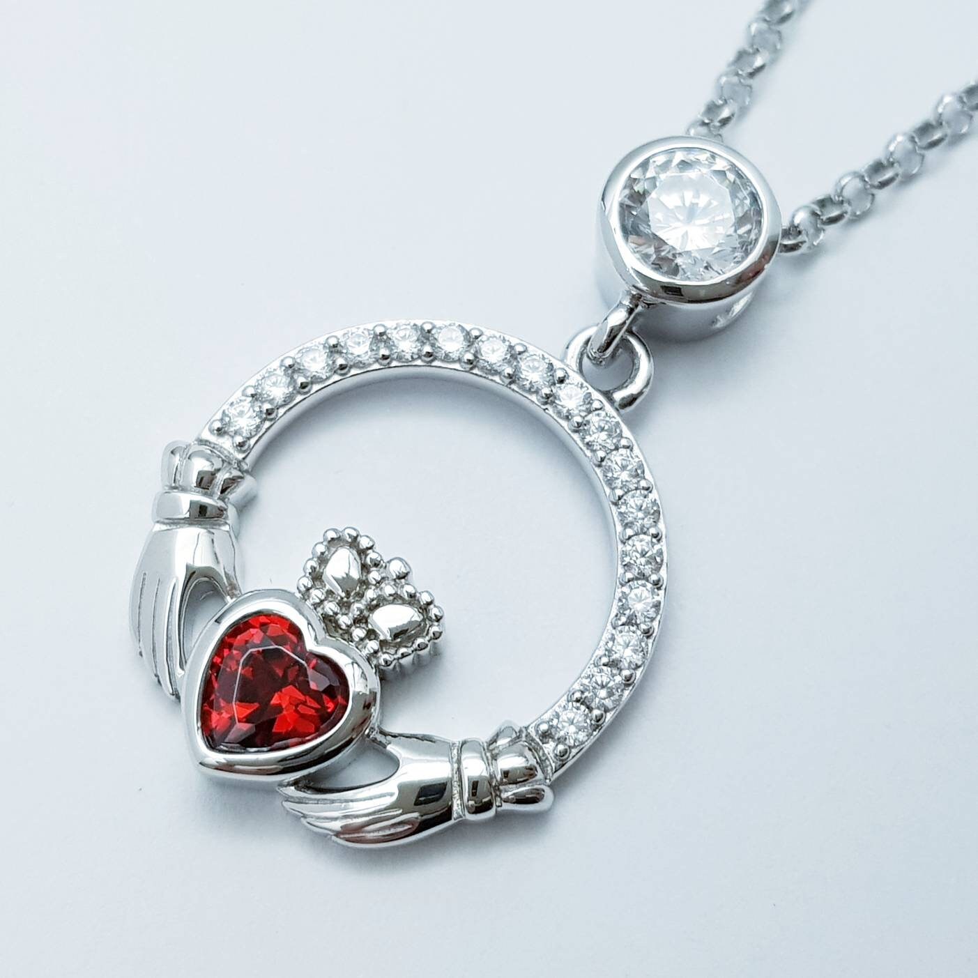 Sterling silver claddagh necklace with red garnet heart shaped stone, January birthstone