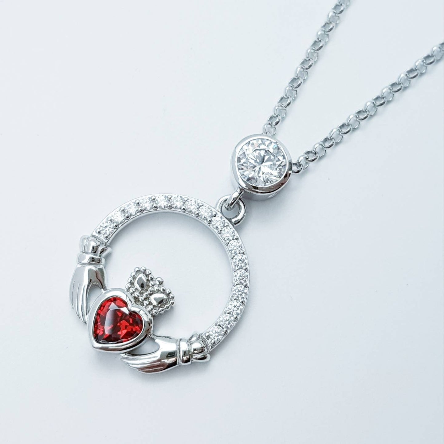 Sterling silver claddagh necklace with red garnet heart shaped stone, January birthstone