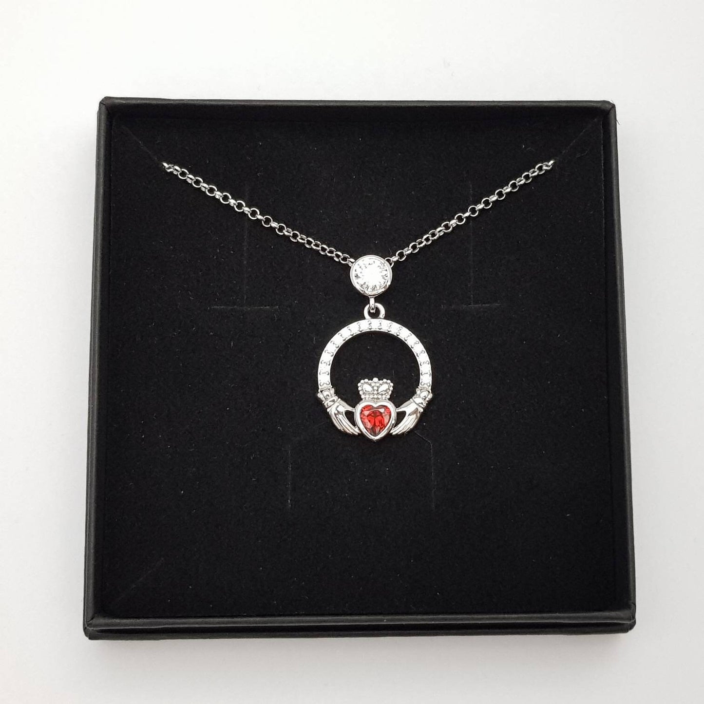Sterling silver claddagh necklace with red garnet heart shaped stone, January birthstone