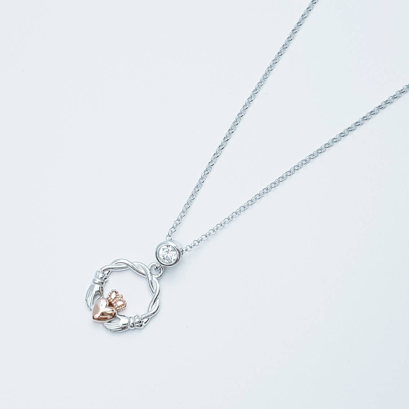 Dainty Sterling Silver claddagh necklace with rose gold plating and intertwined celtic braid.