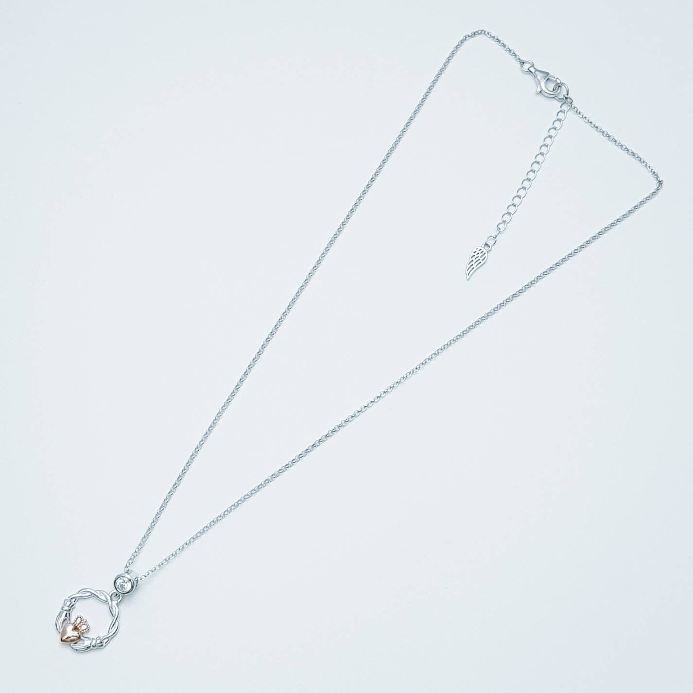 Dainty Sterling Silver claddagh necklace with rose gold plating and intertwined celtic braid.