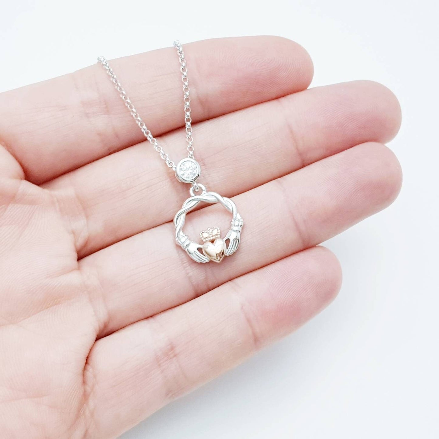 Dainty Sterling Silver claddagh necklace with rose gold plating and intertwined celtic braid.