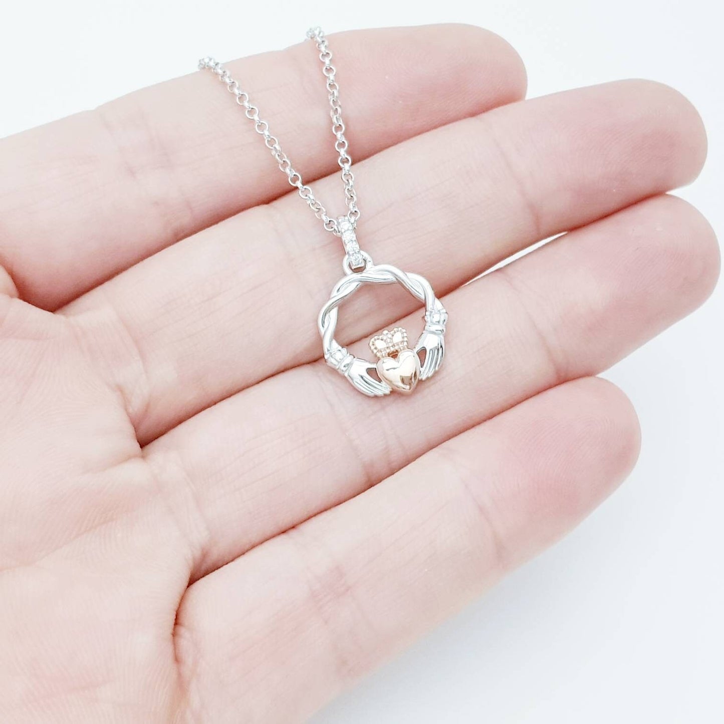 Dainty Sterling Silver claddagh necklace with rose gold plating and intertwined celtic braid.