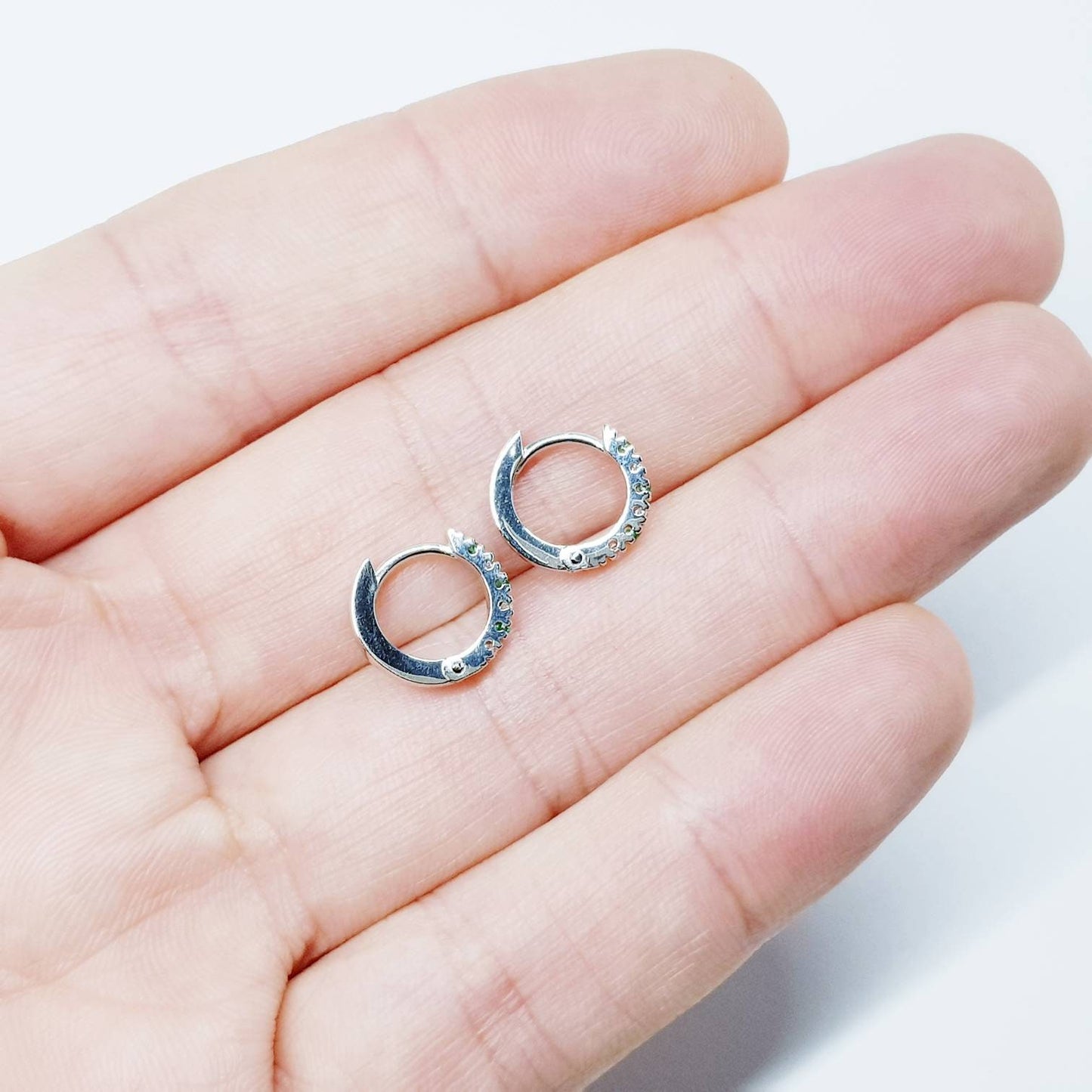 Small silver hoops with green and white CZs, mini hoop earrings, second hole huggies