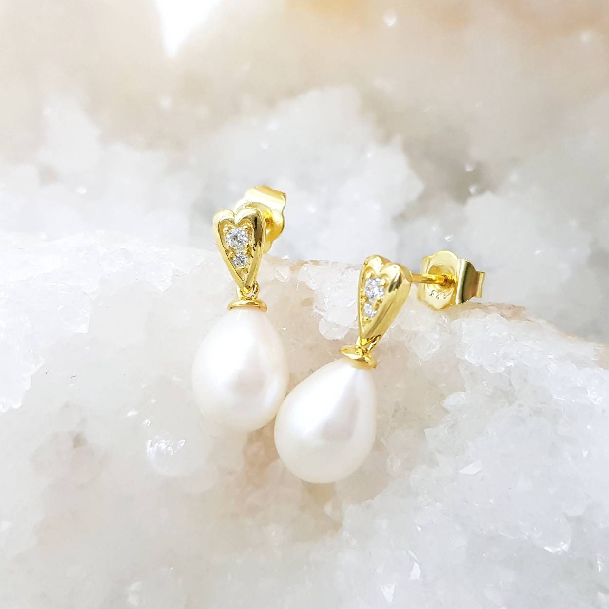 Sterling silver heart shaped earrings with large freshwater pearl drop.