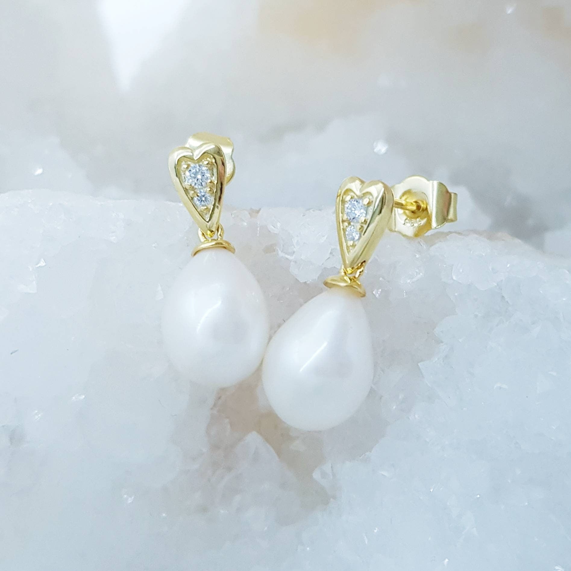 Sterling silver heart shaped earrings with large freshwater pearl drop.