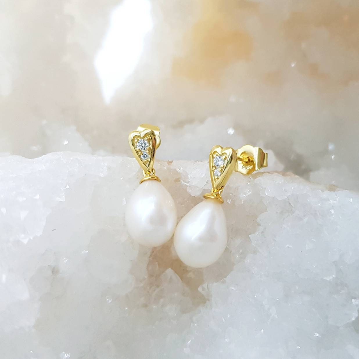 Sterling silver heart shaped earrings with large freshwater pearl drop.