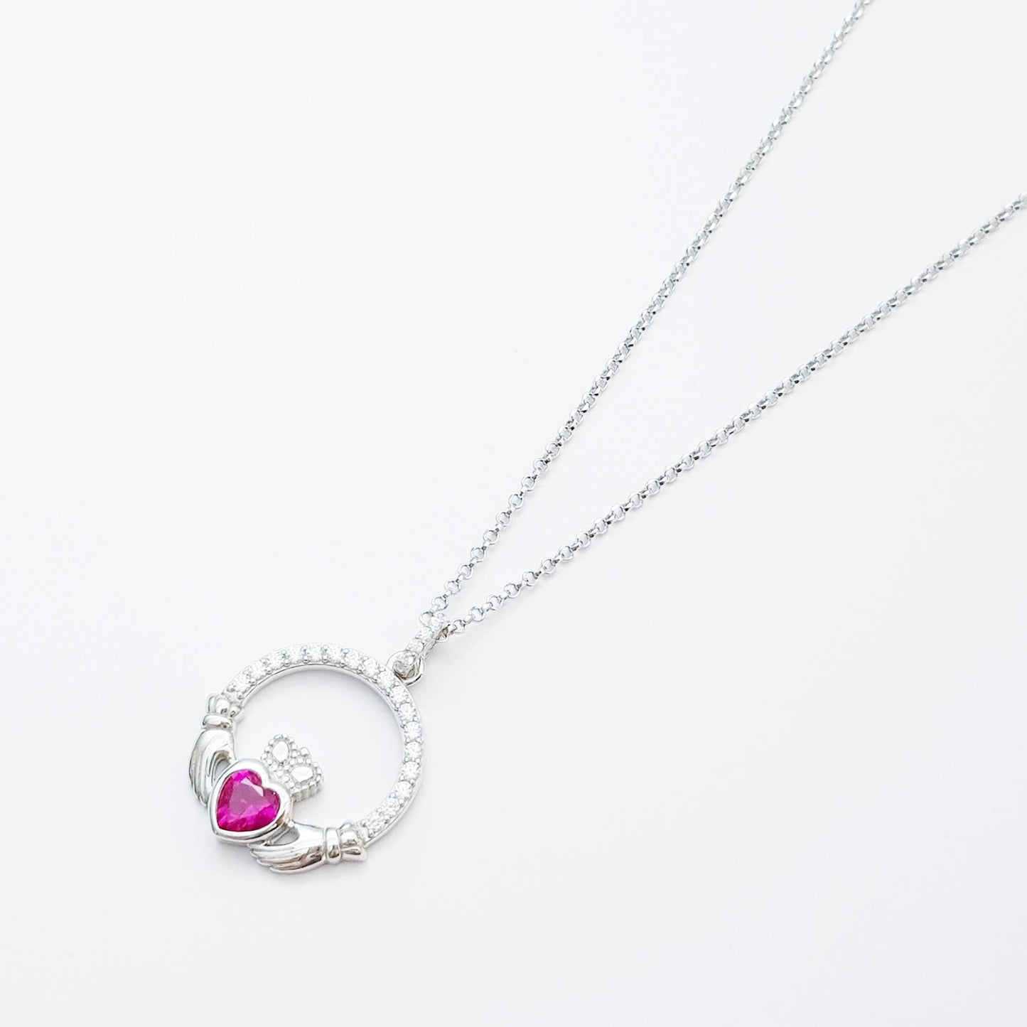 Sterling silver claddagh necklace set with ruby red July birthstone from Ireland