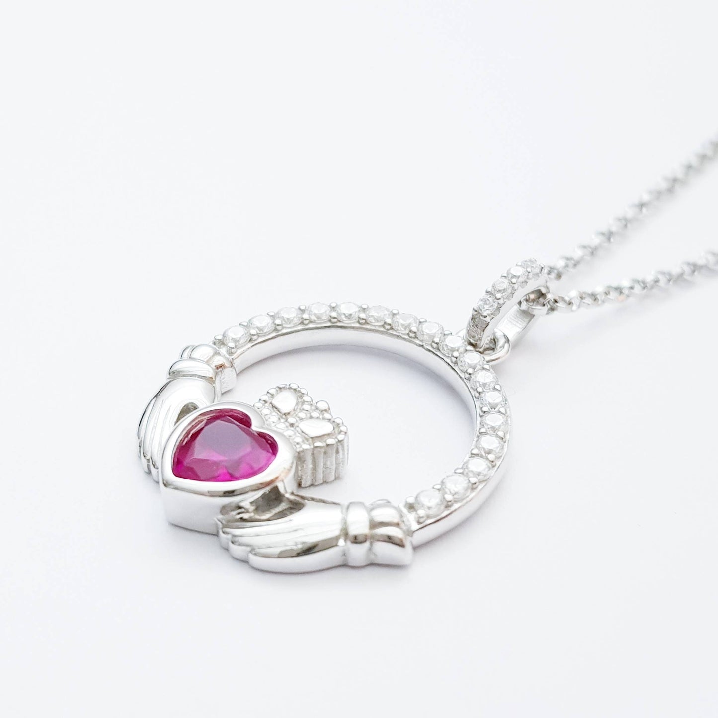 Sterling silver claddagh necklace set with ruby red July birthstone from Ireland