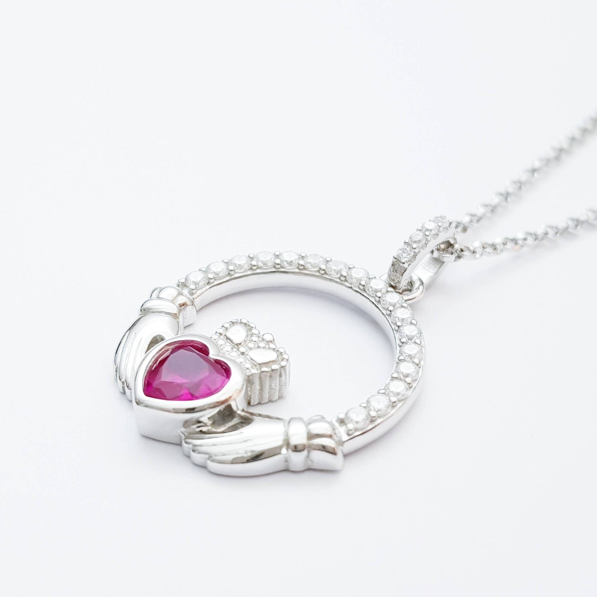 Sterling silver claddagh necklace set with ruby red July birthstone from Ireland