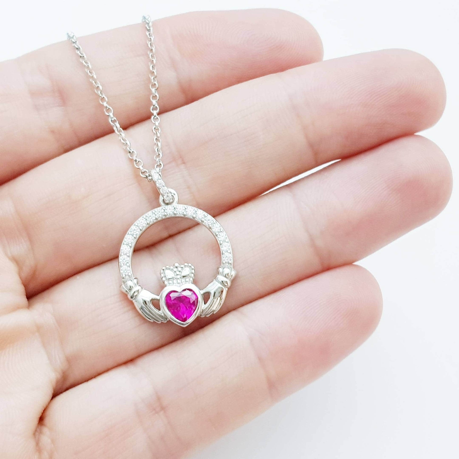 Sterling silver claddagh necklace set with ruby red July birthstone from Ireland