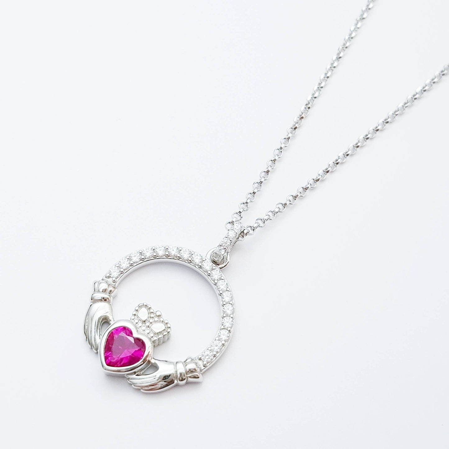 Sterling silver claddagh necklace set with ruby red July birthstone from Ireland