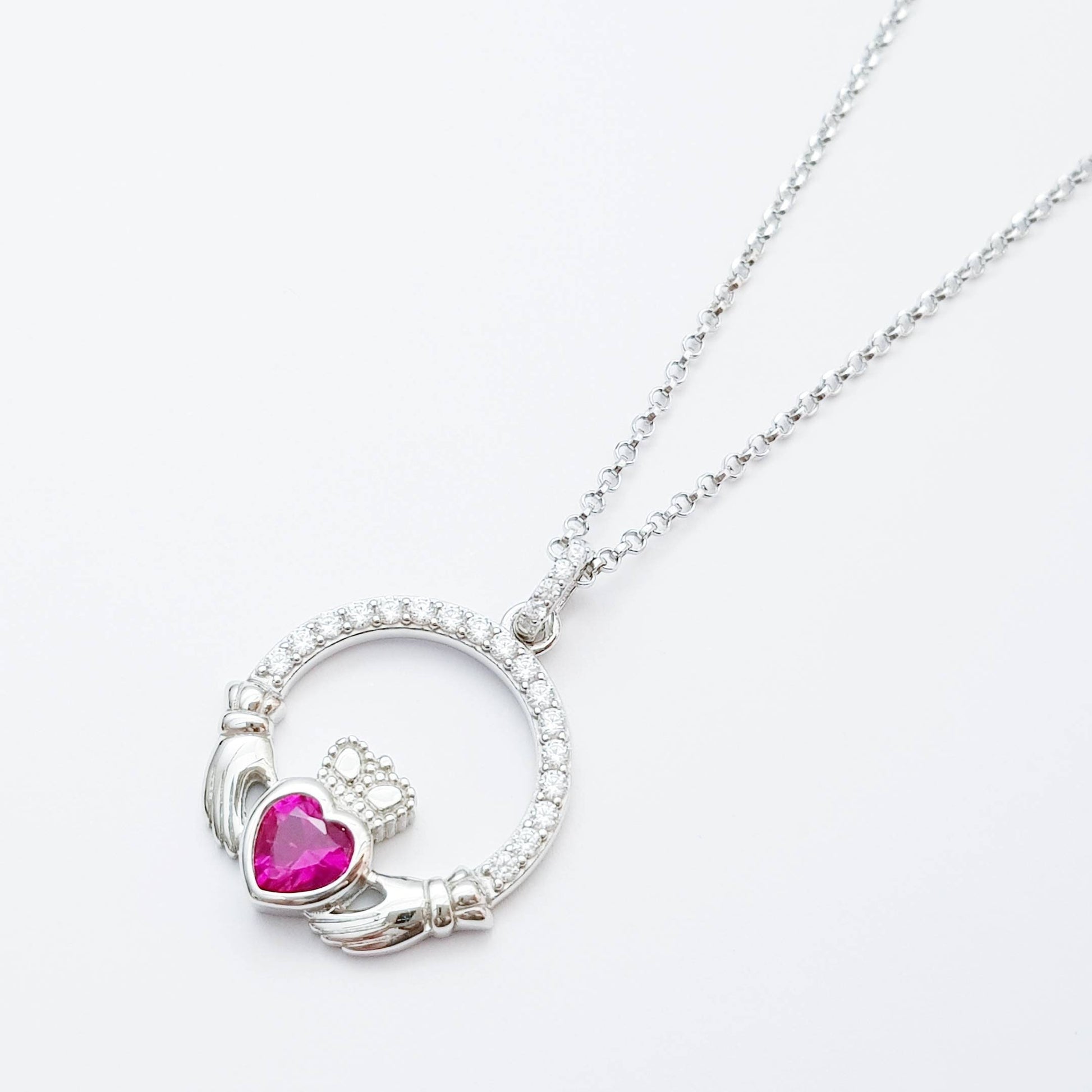 Sterling silver claddagh necklace set with ruby red July birthstone from Ireland