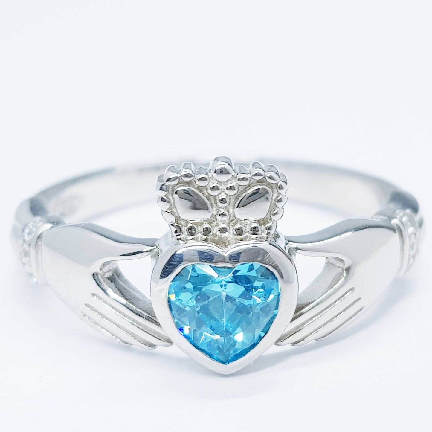 Sterling Silver Claddagh ring set with electric blue heart shaped stone, Irish claddagh rings