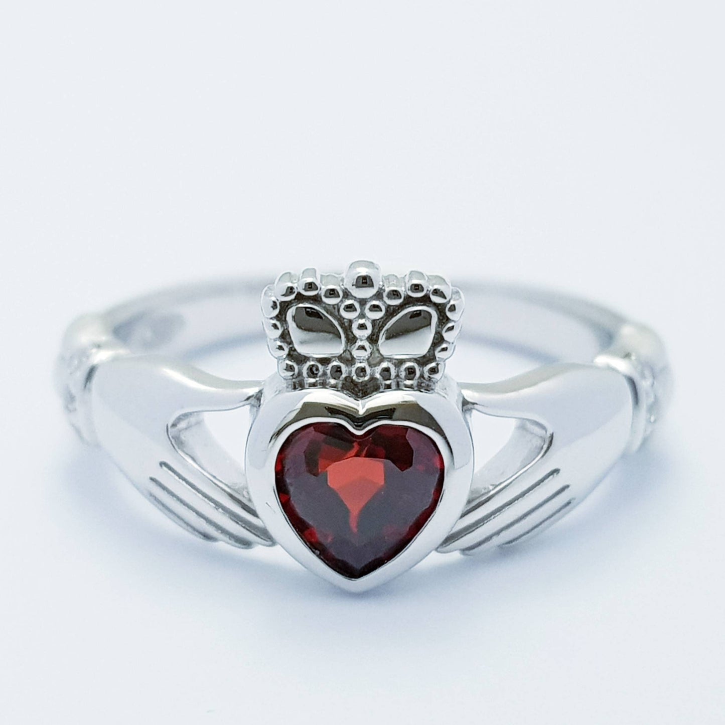 Sterling Silver Claddagh ring set with red garnet heart shaped stone, Irish claddagh rings