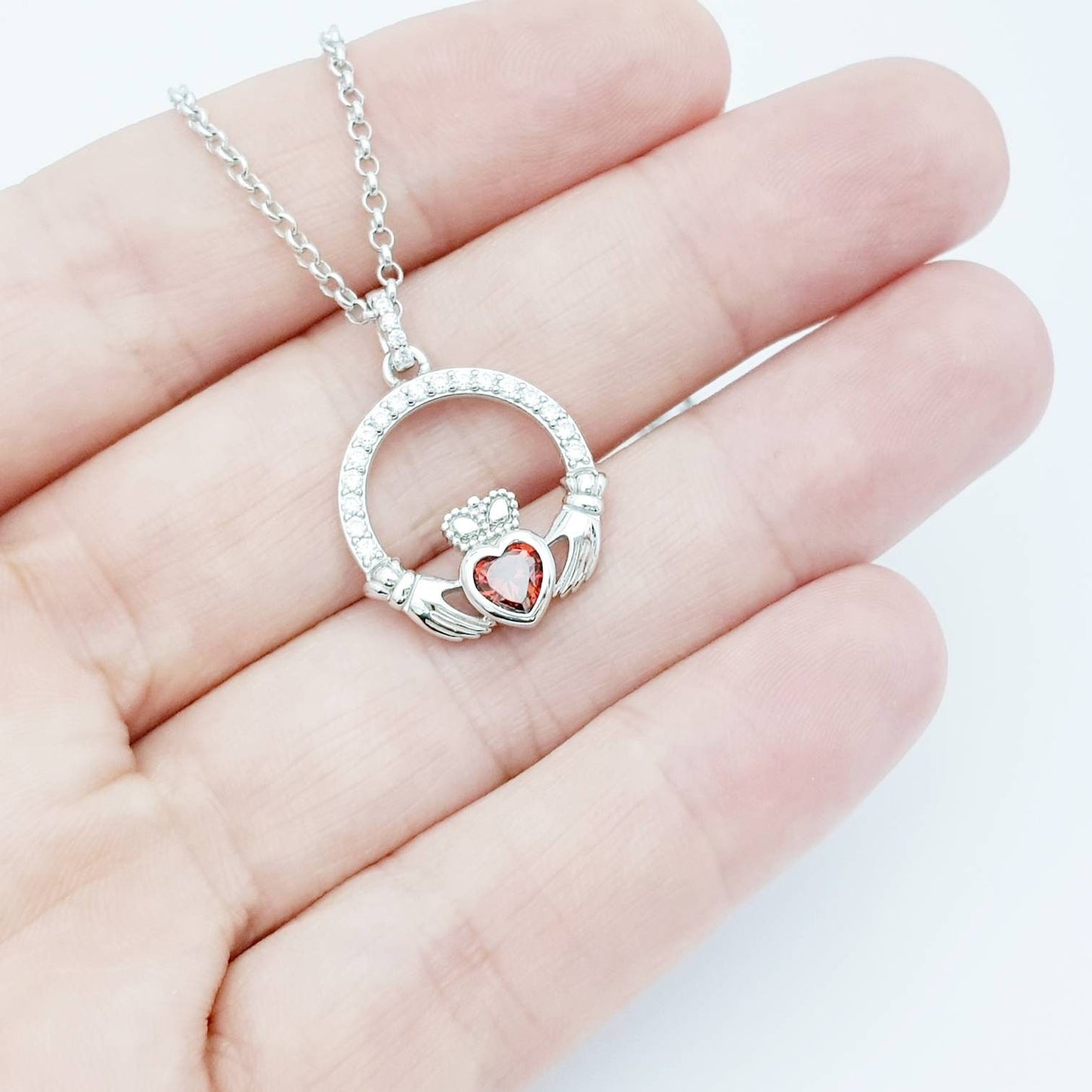 Sterling silver claddagh necklace with red garnet heart shaped stone, January birthstone