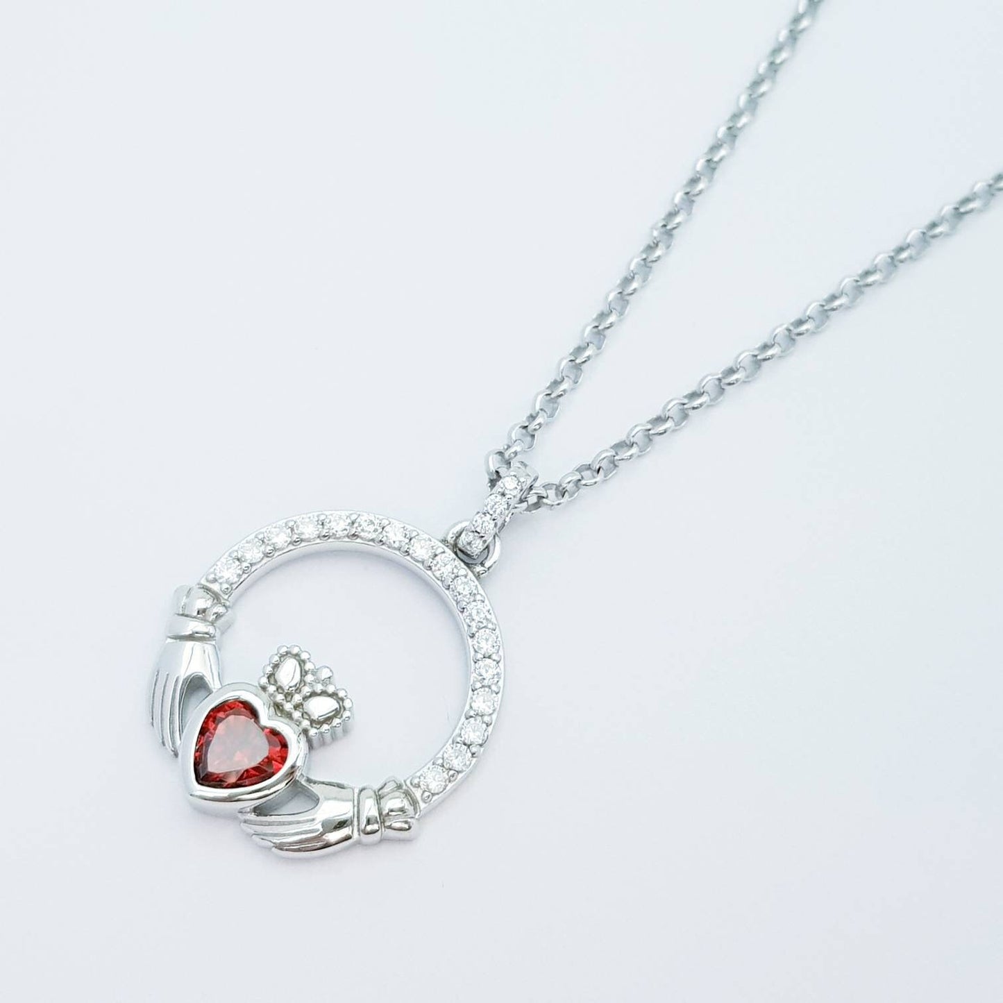 Sterling silver claddagh necklace with red garnet heart shaped stone, January birthstone