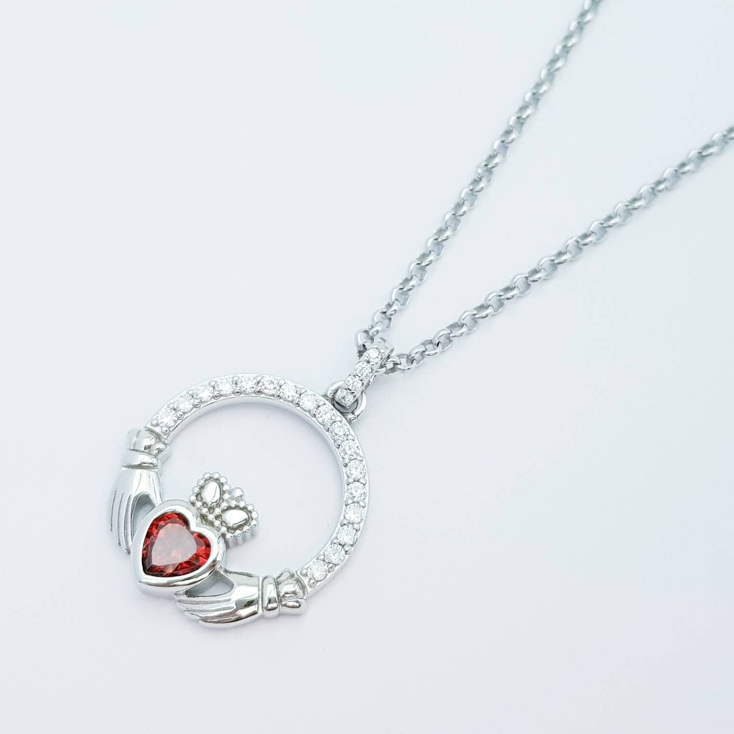 Sterling silver claddagh necklace with red garnet heart shaped stone, January birthstone