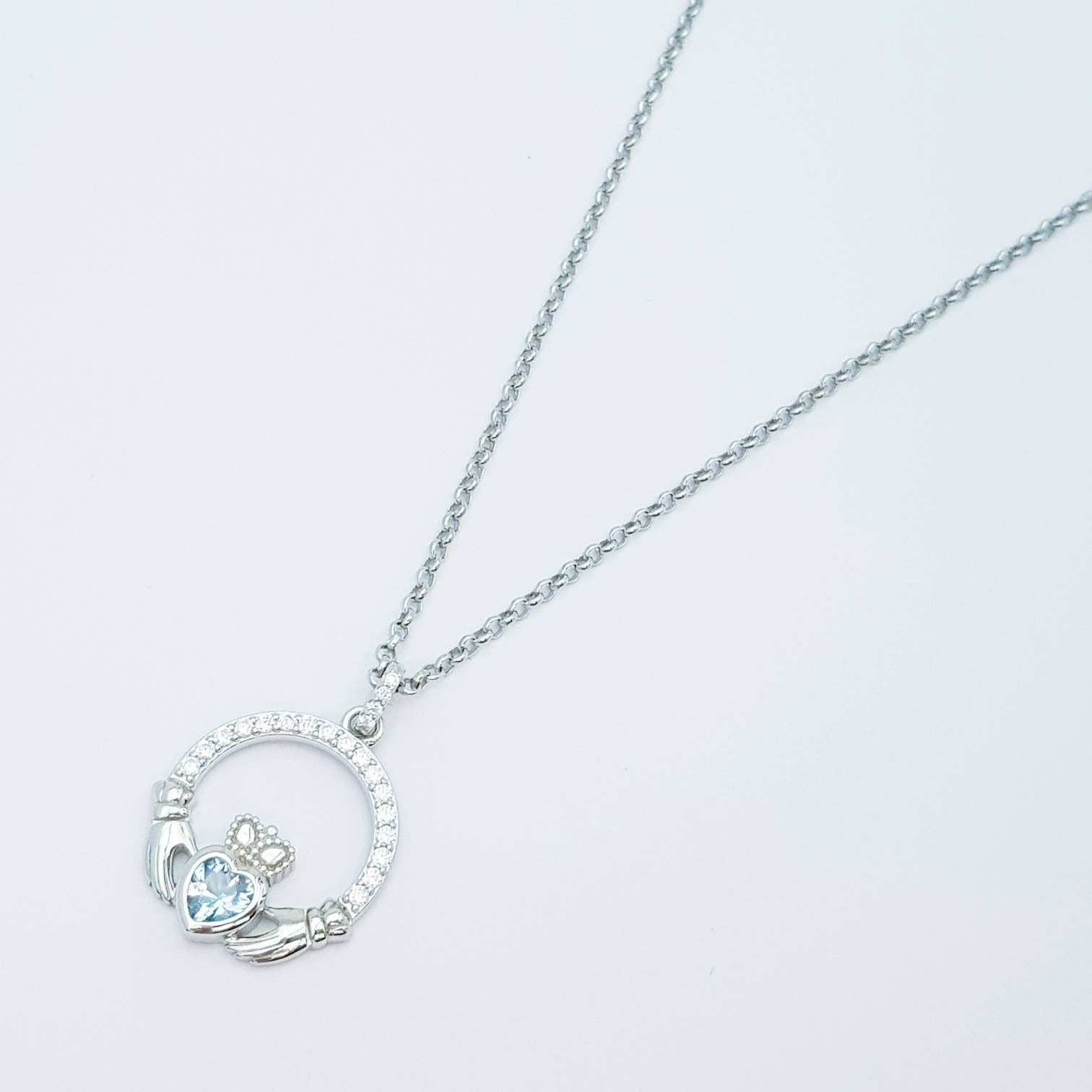 Sterling silver claddagh necklace with light blue aquamarine heart shaped stone, march birthstone
