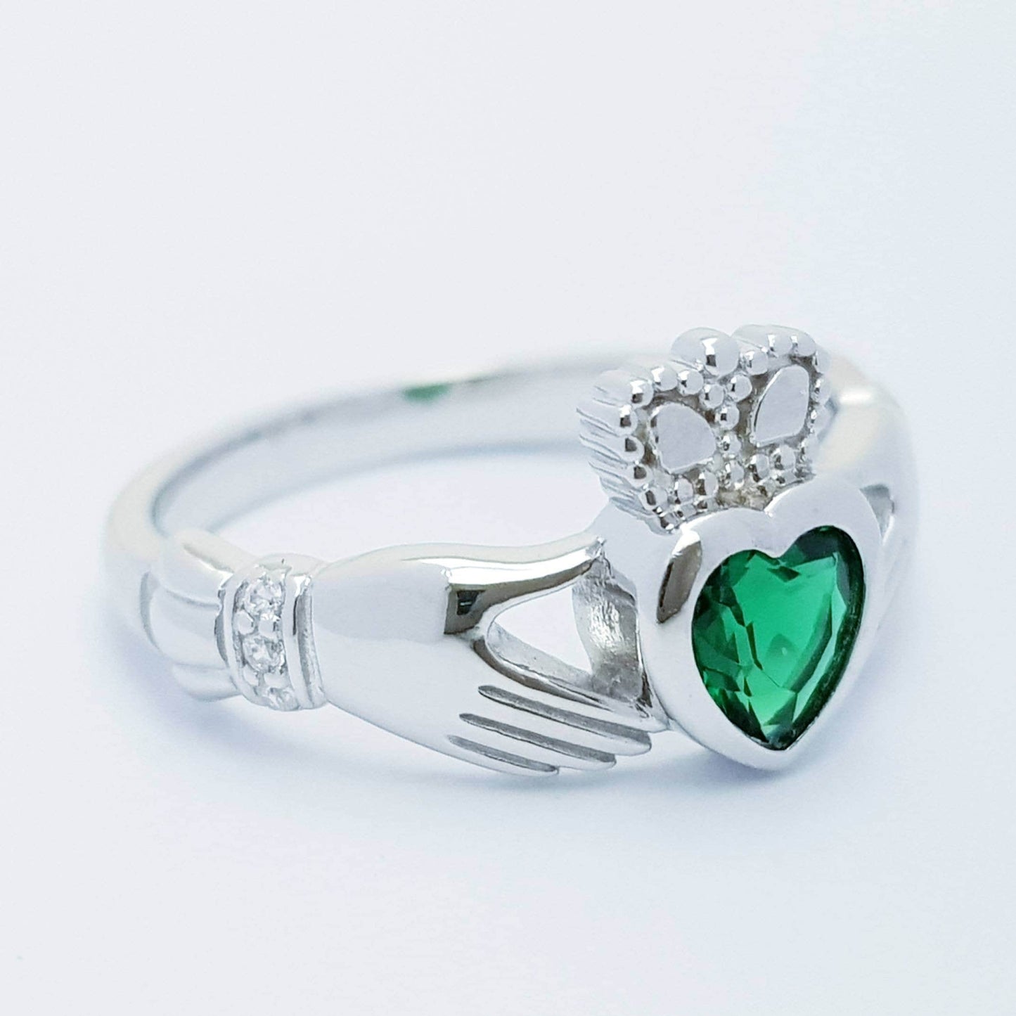 Sterling Silver Claddagh ring set with emerald green heart shaped stone, may birthstone claddagh ring from Ireland