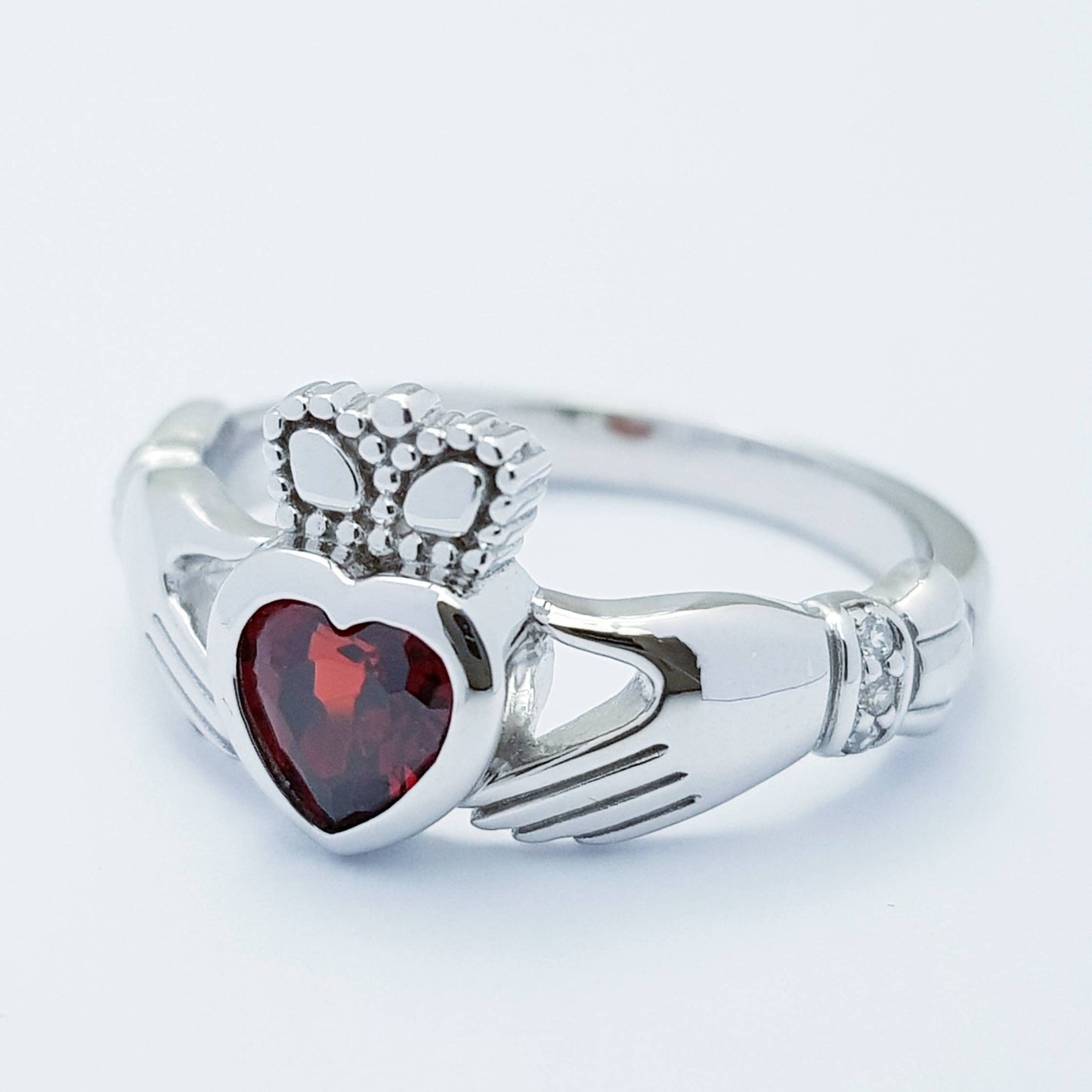 Sterling Silver Claddagh ring set with red garnet heart shaped stone, Irish claddagh rings