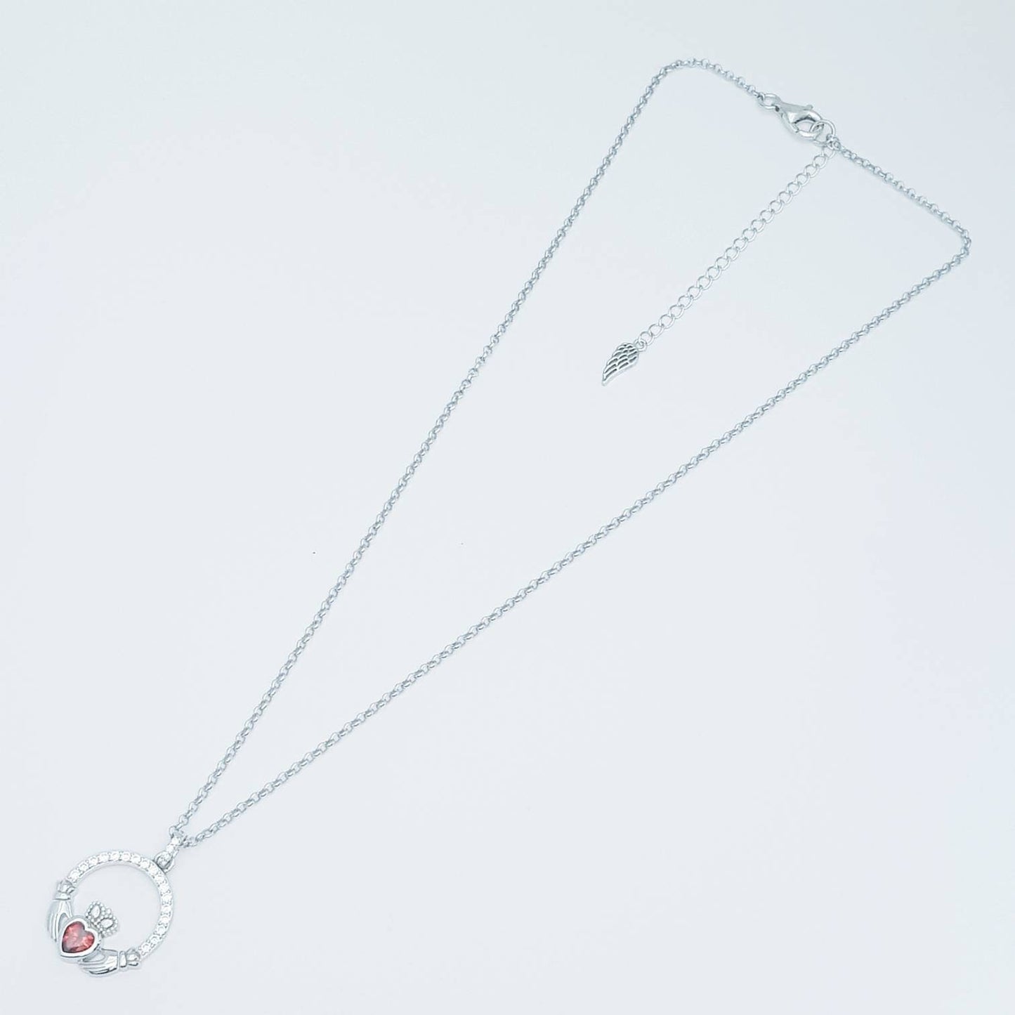 Sterling silver claddagh necklace with red garnet heart shaped stone, January birthstone